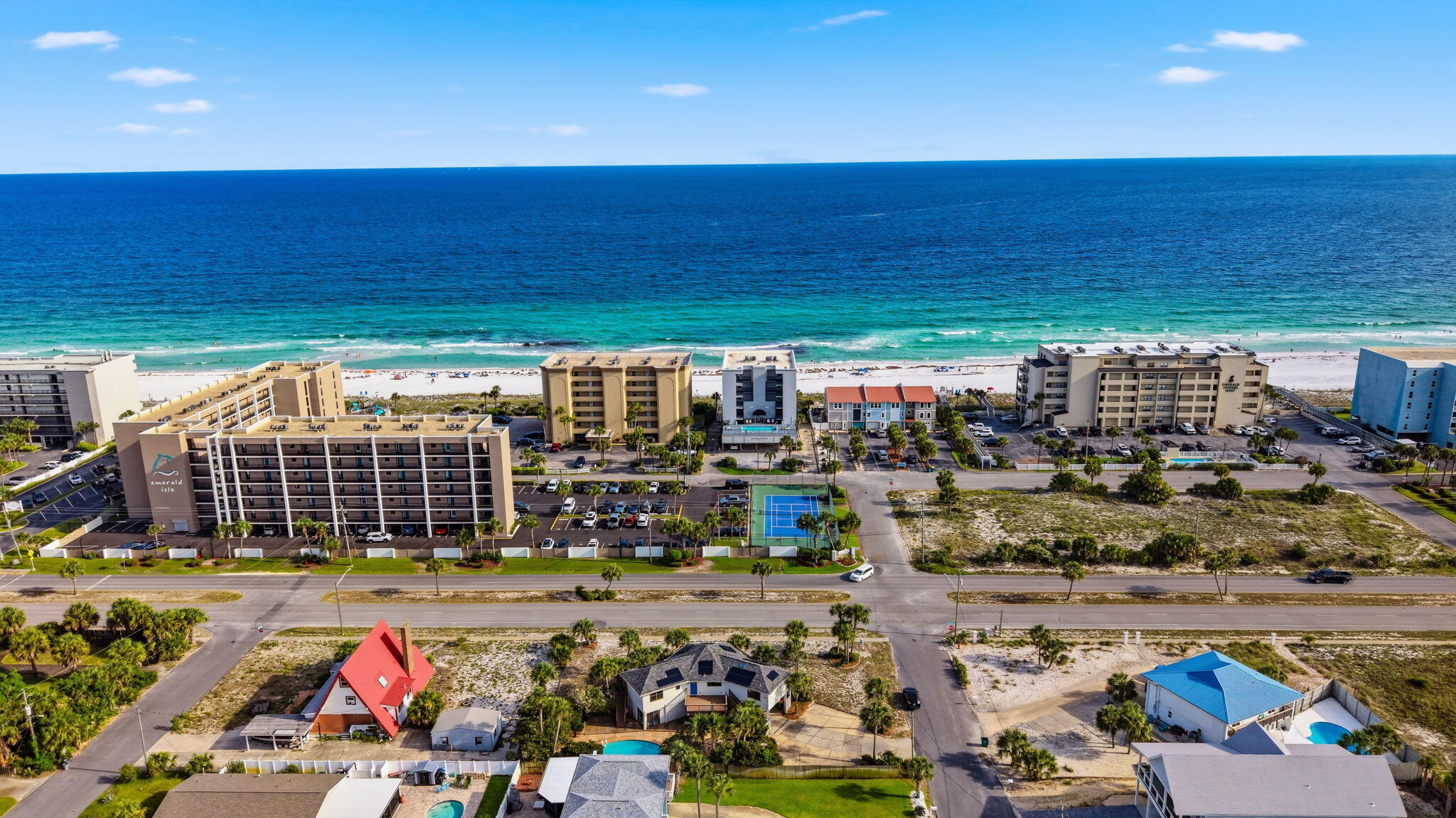 Approximately 639 feet from the sugar-white sand beach, this coastal retreat offers Gulf views, a private pool, and more than 1,600 square feet of outdoor living space. Located in one of Okaloosa Island's most desirable residential neighborhoods where short-term vacation rentals are not permitted, the property delivers a rare combination of beach proximity, privacy, and relaxed coastal living.

One of the home's most impressive features is its exceptional outdoor living design. With over 1,000 square feet of elevated decking plus additional covered outdoor areas and patio space, you'll enjoy Gulf breezes, beautiful sunrises, vibrant sunsets, and multiple areas designed for entertaining, relaxing, and creating lasting memories with family and friends.

Inside, the spacious open-concept floor plan is designed for comfortable everyday living and effortless entertaining. The chef's kitchen serves as the heart of the home and features custom cabinetry, abundant storage, granite countertops, and an impressive 8' x 11' center island topped with a single slab of granite. Walls of windows fill the living spaces with natural light while capturing views toward the Gulf. The home's thoughtful layout offers comfortable living spaces for both full-time residents and those seeking the perfect second-home retreat along the Emerald Coast. After a day at the beach, unwind by the private pool, host gatherings on the expansive decks, or take a short stroll to nearby Santa Rosa Sound access for paddleboarding, kayaking, fishing, and boating. The generous corner lot provides additional privacy and outdoor space rarely found this close to the beach.

Unlike many beach communities, this neighborhood offers a quieter atmosphere with homeowners and second-home residents rather than the constant turnover associated with weekly vacation rentals. Conveniently located near dining, shopping, entertainment, and area attractions, this property allows you to enjoy the best of Okaloosa Island while maintaining the privacy and comfort of a true residential setting.

Whether you're searching for a primary residence, seasonal getaway, or family beach retreat, this home presents a unique opportunity to enjoy Gulf views, beach access, a private pool, and extensive outdoor living space in one of the Island's most sought-after locations.