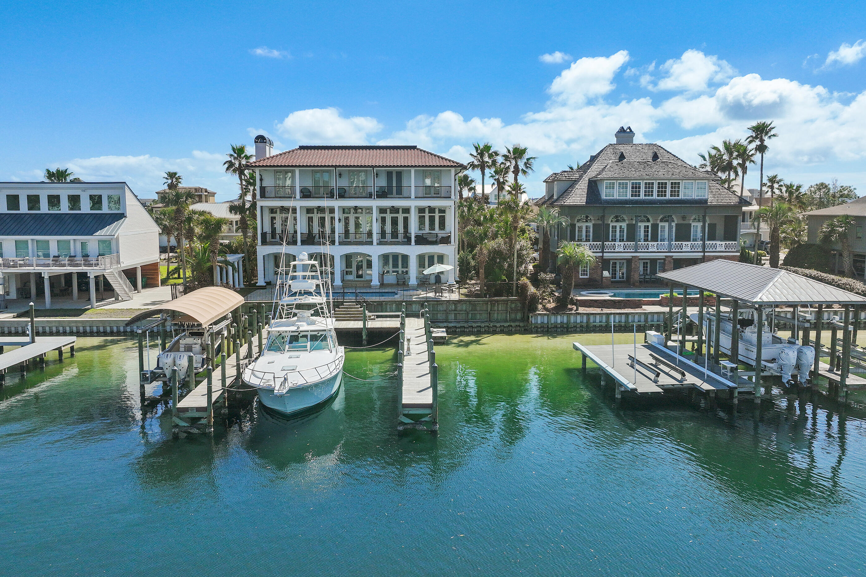 Welcome to 609 Lagoon Drive, a yachtsman's dream, this harbor-front luxury legacy home offers an exceptional opportunity to own on prestigious Holiday Isle.Positioned on deep water with a private boat slip accommodating a 70+ foot yacht, this property encompasses 90 feet of waterfront footage ideal for those who embrace the boating and fishing lifestyle.Spanning 5,192 square feet, this estate has been cherished as a family vacation home for almost two decades, designed for gathering, entertaining, and creating lasting memories. 
This home boasts beautiful hand selected white pine floors throughout, exposed hand hewn beams,  chefs kitchen with commercial grade appliances, custom cabinetry and stunning harbor views from every floor. The master suite situated on the third floor offers his and hers walk in cedar closets, separate vanities, garden tub and a walk in shower.
The french doors off of the master suite open directly to the luxurious covered balcony with panoramic views of the Destin Harbor to enjoy the beautiful sunsets over the water. 
A private study with fireplace directly off of the master suite and an elevator are just a few of the many amazing details that encompass 609 Lagoon Drive.
Enjoy the convenience of the Destin Water Taxi for evenings out, and waterside dining. Just a short 5 minute walk or quick golf cart ride to the beautiful waters and beaches of the Gulf.
Contact Catherine Williams to find out more details or for a private showing.

Buyer to verify all dimensions
