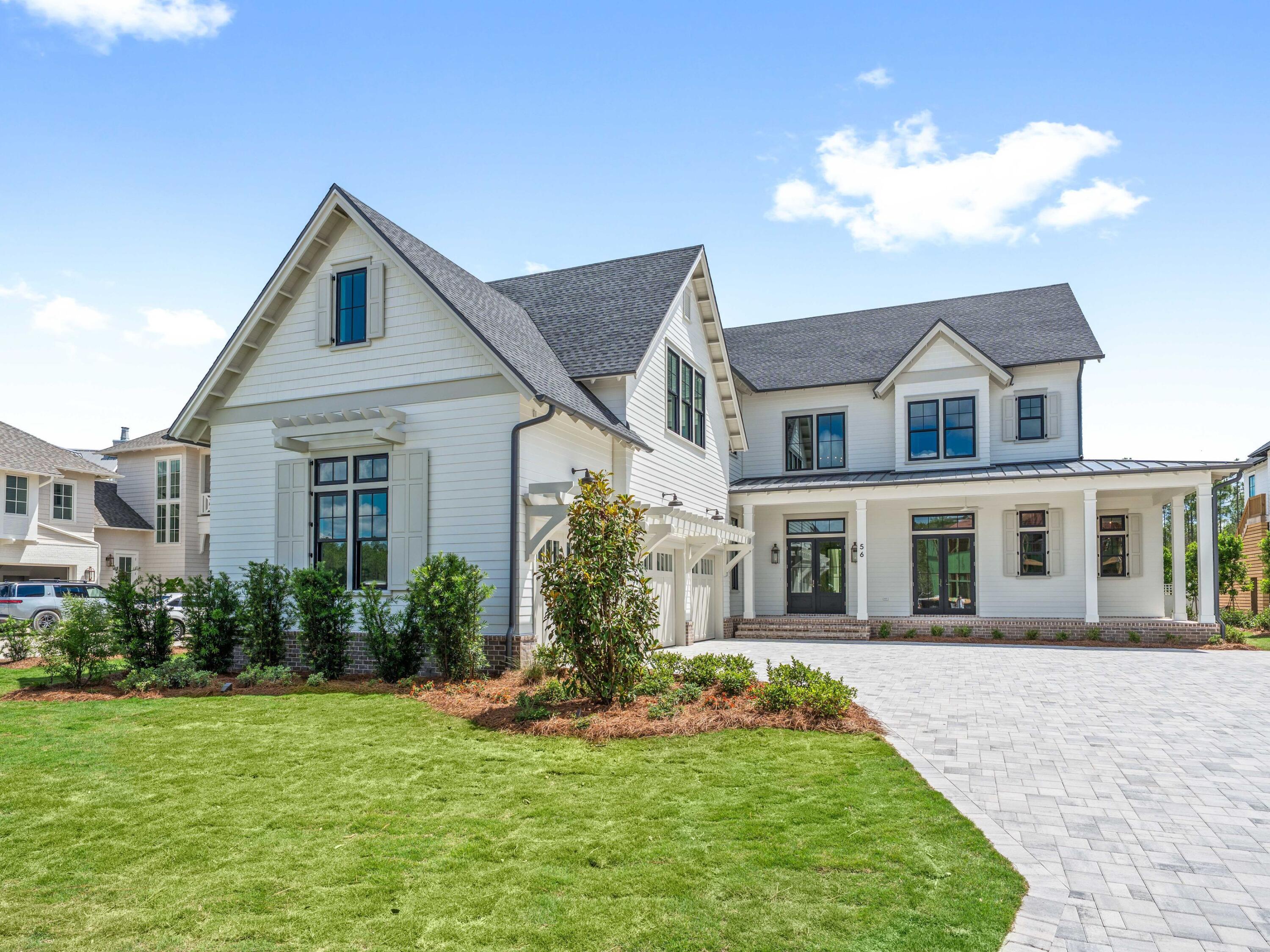 Located within the prestigious Watersound Camp Creek community, 56 South Southern Cross Lane stands as a magnificent estate home that harmoniously blends contemporary elegance with classic coastal design. This exquisite residence spans an impressive 5,600 square feet and features six bedrooms, a study, five full bathrooms, and an additional powder bath.
The light-filled entryway welcomes guests into open spaces defined by curated features and finishes that are seamlessly integrated into every detail. Arched hallways, transom windows, Venetian plaster accents, shiplap and wood-beamed ceilings, and intricate tile work are just a few highlights of the unique character evident throughout the residence.

On the first level, the 12'-high ceilings showcase the custom staircase and wood accent walls. The expansive kitchen, living, and dining areas are well appointed and connect seamlessly via Nano doors to the screened porch with a brick fireplace and a summer kitchen with a vented grill, sink, and beverage refrigerator. An outdoor retreat offers a 15 x 40 heated pool, a 7 x 16 spa, an outdoor paver area with a gas fire pit which is the perfect spot to relax after a day at the beach, and a spacious manicured yard.
The gourmet kitchen is expertly appointed with custom cabinetry, a stunning quartz backsplash, Wolf and Sub-Zero appliances, and designer lighting. There is a custom nook with cabinetry, open shelves, and a wine fridge, as well as a scullery with an additional sink,  beverage fridge, and dishwasher. The primary suite serves as a true owner's retreat on the first level with dedicated sliding doors to the patio, a spa ensuite with large shower, soaking tub and his and hers walk-in closets. A spacious study with glass doors, a walk-in pantry, and first-floor laundry with a sink and ample cabinetry complete the first floor. There are five spacious guest suites, a second living area which is the perfect spot for kids, a breakfast bar, additional laundry, and a flex room on the second level. 

This exceptional property presents a unique opportunity for discerning homeowners seeking a luxurious lifestyle within proximity to the pristine waters of the 30A coast. Ownership in Watersound Camp Creek grants exclusive access to the Watersound Club, which encompasses three golf courses, including the Tom Fazio-designed Camp Creek course and the newly constructed Davis Love III-designed The Third course. The club further offers complimentary chair and umbrella service at the Gulf-front Beach Club, an expansive 11,000-square-foot wellness center, an array of resort pools, and numerous private dining establishments.