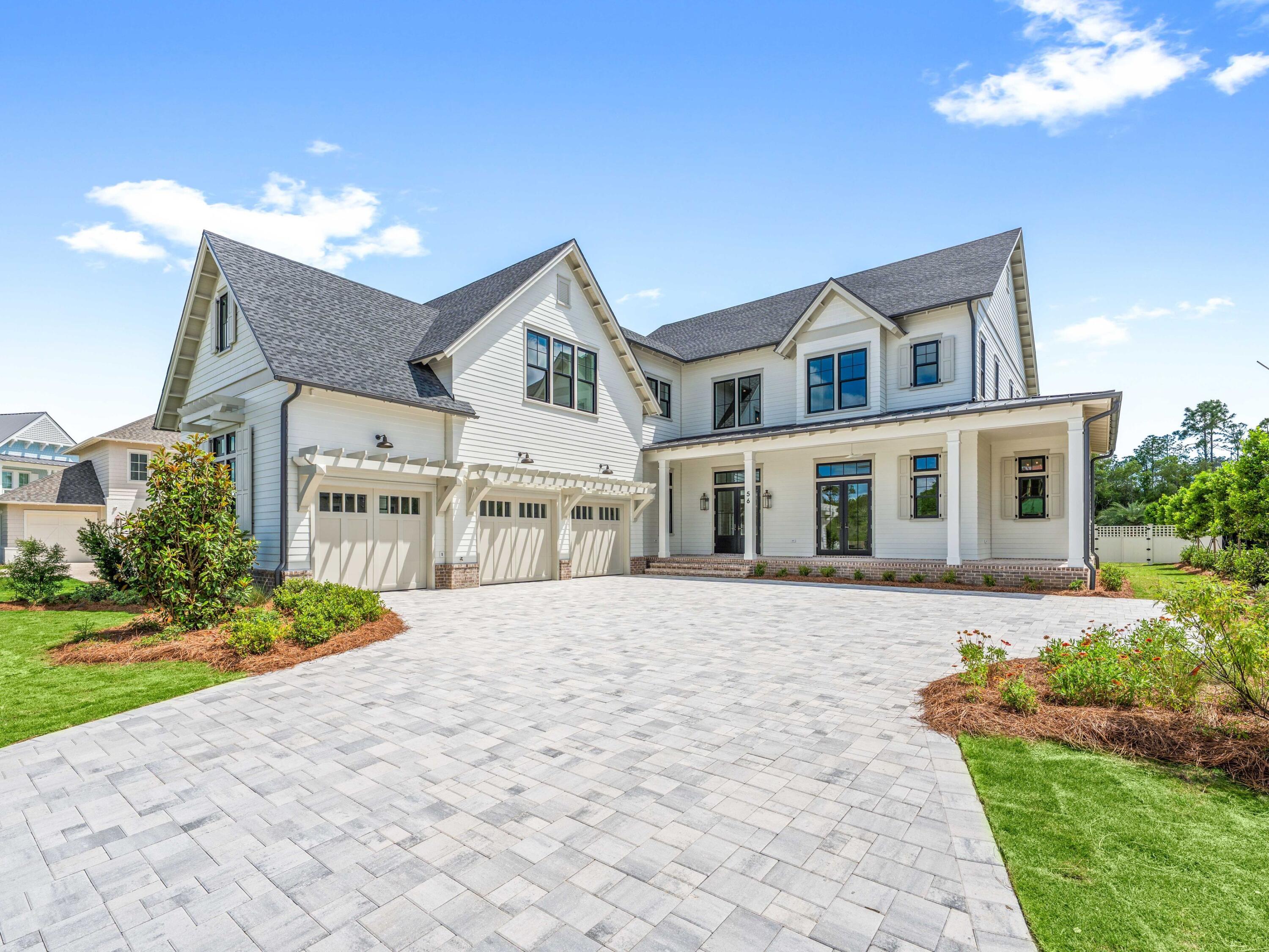 Located within the prestigious Watersound Camp Creek community, 56 South Southern Cross Lane stands as a magnificent estate home that harmoniously blends contemporary elegance with classic coastal design. This exquisite residence spans an impressive 5,600 square feet and features six bedrooms, a study, five full bathrooms, and an additional powder bath.
The light-filled entryway welcomes guests into open spaces defined by curated features and finishes that are seamlessly integrated into every detail. Arched hallways, transom windows, Venetian plaster accents, shiplap and wood-beamed ceilings, and intricate tile work are just a few highlights of the unique character evident throughout the residence.

On the first level, the 12'-high ceilings showcase the custom staircase and wood accent walls. The expansive kitchen, living, and dining areas are well appointed and connect seamlessly via Nano doors to the screened porch with a brick fireplace and a summer kitchen with a vented grill, sink, and beverage refrigerator. An outdoor retreat offers a 15 x 40 heated pool, a 7 x 16 spa, an outdoor paver area with a gas fire pit which is the perfect spot to relax after a day at the beach, and a spacious manicured yard.
The gourmet kitchen is expertly appointed with custom cabinetry, a stunning quartz backsplash, Wolf and Sub-Zero appliances, and designer lighting. There is a custom nook with cabinetry, open shelves, and a wine fridge, as well as a scullery with an additional sink, beverage fridge, and dishwasher. The primary suite serves as a true owner's retreat on the first level with dedicated sliding doors to the patio, a spa ensuite with large shower, soaking tub and his and hers walk-in closets. A spacious study with glass doors, a walk-in pantry, and first-floor laundry with a sink and ample cabinetry complete the first floor. There are five spacious guest suites, a second living area which is the perfect spot for kids, a breakfast bar, additional laundry, and a flex room on the second level. 

This exceptional property presents a unique opportunity for discerning homeowners seeking a luxurious lifestyle within proximity to the pristine waters of the 30A coast. Ownership in Watersound Camp Creek grants exclusive access to the Watersound Club, which encompasses three golf courses, including the Tom Fazio-designed Camp Creek course and the newly constructed Davis Love III-designed The Third course. The club further offers complimentary chair and umbrella service at the Gulf-front Beach Club, an expansive 11,000-square-foot wellness center, an array of resort pools, and numerous private dining establishments.