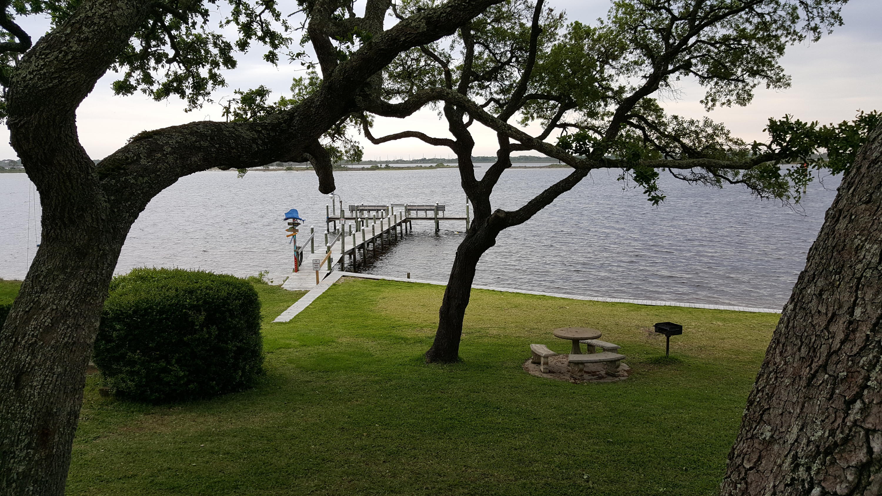 Cute, updated first floor condo with Courtyard that has beautiful majestic oaks that provide for plenty of shade. Unit has new floors throughout, white kitchen cabinets and new appliances. Complex has large inground pool, private beach, cement picnic tables, fishing dock, laundry facility and party room. Check the great 3D tour.