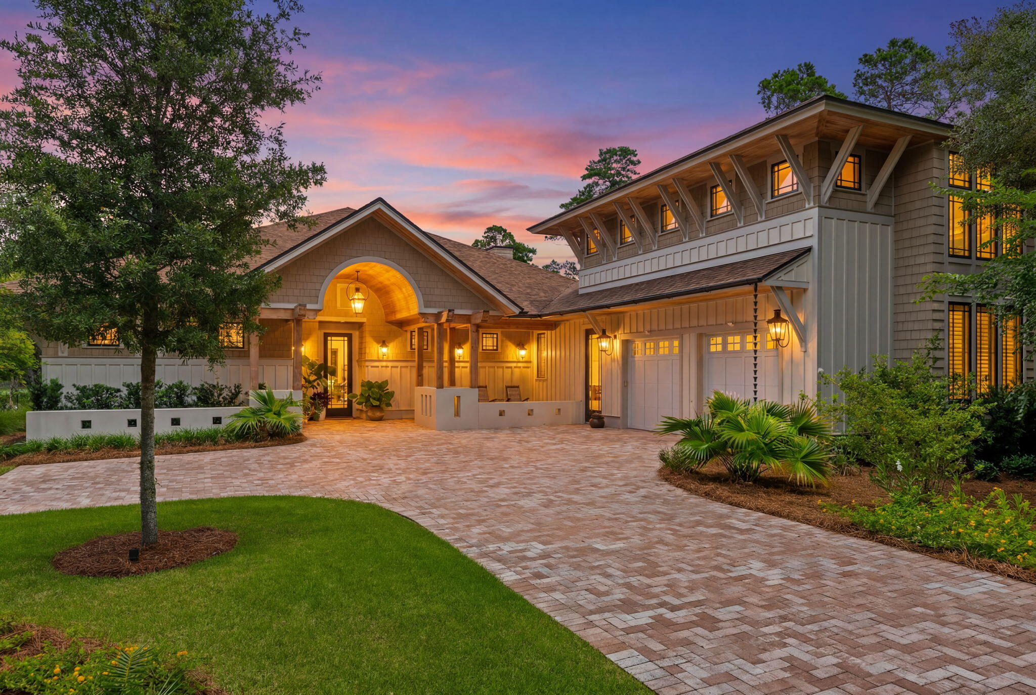 Nestled behind the guarded gates of the exclusive 734-acre Wild Heron preserve, this remarkable Coastal Craftsman estate, masterfully crafted by Regal Stephens, combines unparalleled privacy with world-class design. The exterior immediately commands attention with its striking cedar shake siding, beautifully laid paver driveway, deep exposed-wood brackets, and a dramatic arched entry pavilion. Inside, the home seamlessly blends casual coastal sophistication with meticulous custom millwork, showcasing warm wide-plank hardwood floors, a stunning whitewashed stone fireplace, and a striking tray ceiling wrapped in natural wood beams and blonde wood tongue-and-groove paneling. The chef's kitchen is an absolute showstopper, featuring sleek inset cabinetry, open floating shelving, leathered quartz countertops, an elegant mosaic tile backsplash, a professional gas range under a grand custom hood, a pot filler, and a hidden walk-in pantry behind a crisp white barn door. Retreat to the elegant primary suite, complete with a crisp coastal color palette, built-in custom cabinetry, and its own private linear fireplace. Upstairs, a sprawling, versatile secondary living space or guest suite features a built-in kitchenette with a bar sink, beverage fridge, and microwave. The indoor-outdoor flow is unmatched, leading to a massive, fully screened outdoor living compound backing up to a serene, wooded landscape. This backyard oasis features a resort-style pool and integrated spillover  hot tub wrapped in premium travertine decking, luxury in-water lounge chairs, a built-in summer kitchen with a professional-grade DCS grill, and a magnificent tongue-and-groove paneled lanai with a soaring stone-accent wall and linear fireplace. Seamlessly blending into the natural landscape, the backyard layout offers a coveted peek-a-boo view of a tranquil pond, frequently visited by local herons, alongside beautiful views overlooking the 13th hole of the course. Living in Wild Heron means embracing a lifestyle centered on nature and luxury along the shores of Lake Powell, North America's largest coastal dune lake, with world-class amenities including a lakeside resort pool, a fitness center, a boathouse, & firepit.
Watersound Club members can enjoy access to the renowned Greg Norman-designed Sharks Tooth Golf Course, clubhouse, & tennis.