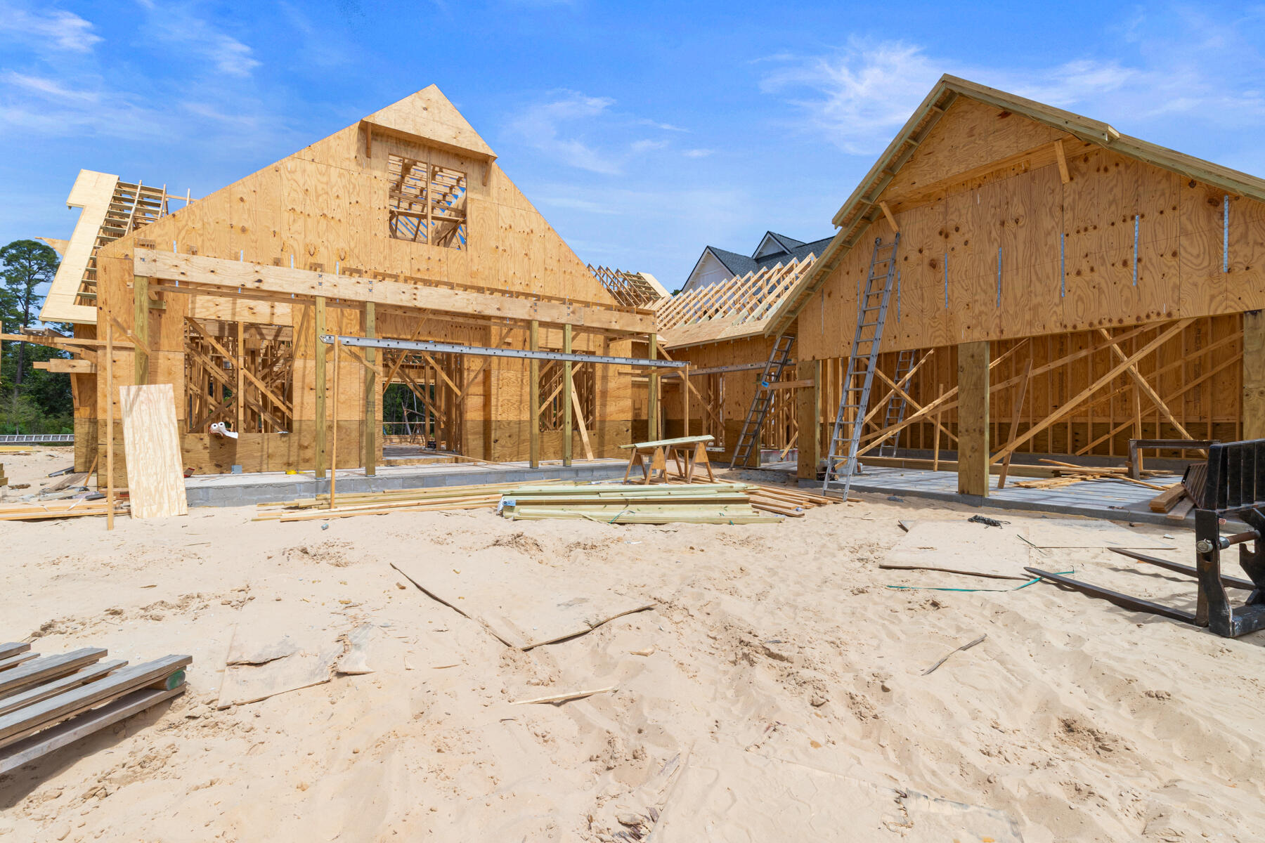 This custom residence offers 3,500 square feet, 5 bedrooms, 5.5 bathrooms, and a 2-car garage with a dedicated golf cart bay, located on Homesite 61 in Powell Landing West at Watersound Origins. Set on a 140' deep homesite with a wooded backdrop and just steps from the community dock at Lake Powell, the property provides direct access to one of the area's defining natural features. Estimated completion is end of August '26.

The front elevation is defined by clean lines, 9-foot exterior doors, and an expanded window package. A covered entry with brick flooring leads into the foyer, where the layout opens toward the main living areas while maintaining separation between private spaces.

The living room is positioned at the rear of the home, defined by vaulted ceilings with exposed wood beams and a wood-burning fireplace with a plaster finish. A 16' sliding glass door extends the space to the rear porch, while the adjacent dining area features a 12' slider, creating multiple access points to the outdoor living areas.

The kitchen is centrally located between the living and dining areas, anchored by a 12-foot island with marble surfaces. Cabinetry extends to conceal a full appliance suite including a 48" refrigeration unit, dual fuel range, and integrated ventilation. A walk-in pantry is paired with a separate wet bar featuring a sink, ice maker, and beverage refrigeration, allowing prep and service areas to function independently.

The primary suite is located at the rear of the home, separated from the secondary bedrooms, with direct access to the outdoor living space. The bath includes a freestanding tub, walk-in shower with bench, and upgraded fixtures, while the closet is divided into a functional his-and-hers layout with custom shelving.

Secondary bedrooms are arranged along the opposite side of the home, each with ensuite baths and walk-in closets, supporting both privacy and flexibility in use.

Outdoor living is fully integrated into the layout. A 10' x 35' pool and spa with upgraded finishes anchors the backyard, complemented by extended paver decking, a summer kitchen, and a screened porch with a wood-burning fireplace and brick flooring. The depth of the homesite allows for defined outdoor living areas while maintaining privacy.

Additional features include 12-foot ceilings throughout, wide-plank wood flooring, solid core interior doors, crown molding in main living areas, upgraded hardware and plumbing fixtures, and a conditioned garage with epoxy flooring and mini-split system.

Located within Powell Landing West, this home offers immediate access to Lake Powell, the community dock, and Watersound Origins amenities including trails, Village Commons, and the Origins Golf Course.

Pricing subject to change as the home progresses and selections are added or removed.