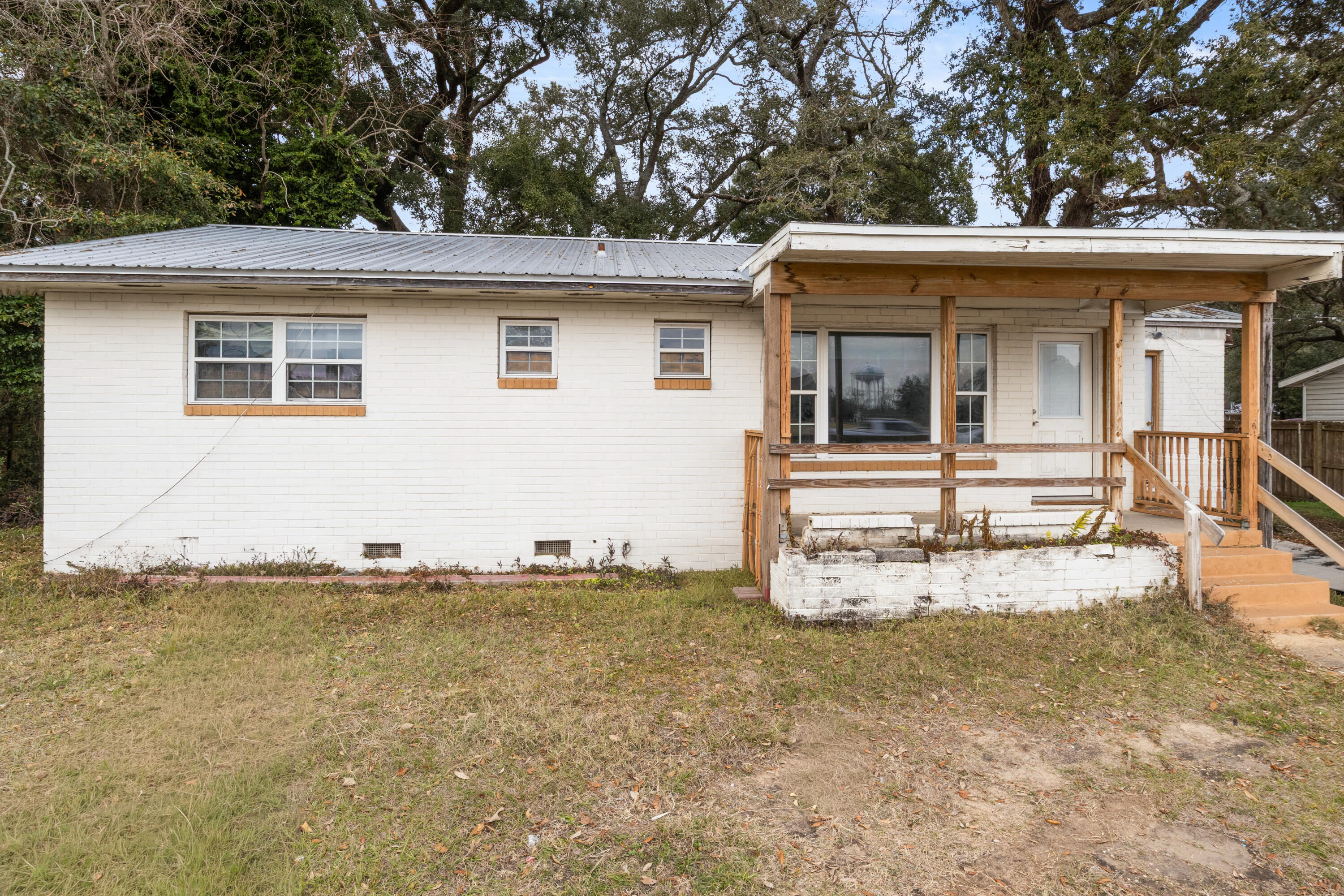 This 3-bedroom, 2-bath ranch in Pensacola offers 1,420 square feet on a 0.24-acre lot with mixed-use zoning (HDMU). Built in 1960, the property provides flexibility for residential or other permitted uses, with no HOA and proximity to I-110 for access across the area.
The single-story layout includes defined living, dining, and kitchen spaces, along with three bedrooms and two full baths. Interior condition reflects the home's age and may offer opportunities for updates or customization based on buyer needs.
The property is connected to public water and sewer and is currently vacant, allowing for immediate access. The exterior includes a covered front porch and paved parking, with a lot size that supports additional use depending on zoning allowances.