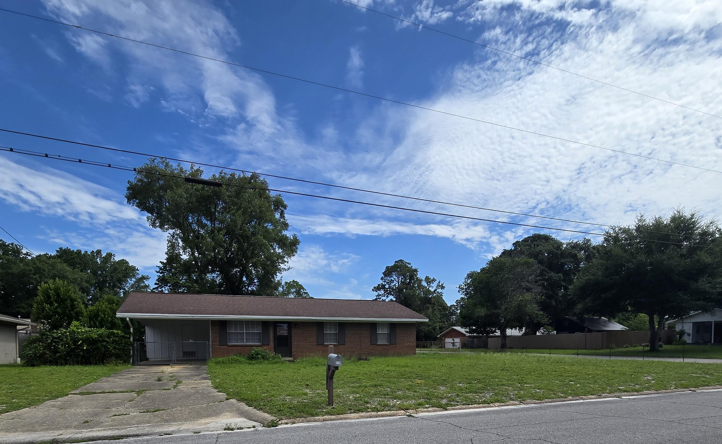 Investor opportunity to purchase an all brick home in the established neighborhood of Oakland Heights. This large corner lot has potential for exterior improvement additions and  is located in an area close to Highway 98. Property is 100% chain link fenced, providing a secure yard for both children and pets to roam freely. The interior needs extensive cosmetic work with some interior and exterior structural work as well. The kitchen will need updating.  All interior walls will need to be painted. Both bathrooms have honeycomb ceramic tile. The kitchen has a flooring product that would be similar to a hard surface, 12'' x 12'' peel and stick surface (not ceramic or VCT tile).  All other flooring has already been removed. Gas HVAC system was replaced in 2017, and the gas water heater was changed out in 2021. One-car carport might be able to be enclosed, creating a garage. Laundry hookups and storage area are situated at the far end of the carport. Property has been priced accordingly and will be sold in its as-is condition. Unfortunately, the house will not qualify for VA or FHA financing. Seller prefers a cash only transaction and will not pay for any buyer closing costs or title insurance. House has been a rental for nearly 25 years with minimal maintenance. Consider bringing your contractor and your vision; let's breathe new life into this house and create an affordable living option as a rental or a purchase for a young first time buyer family.