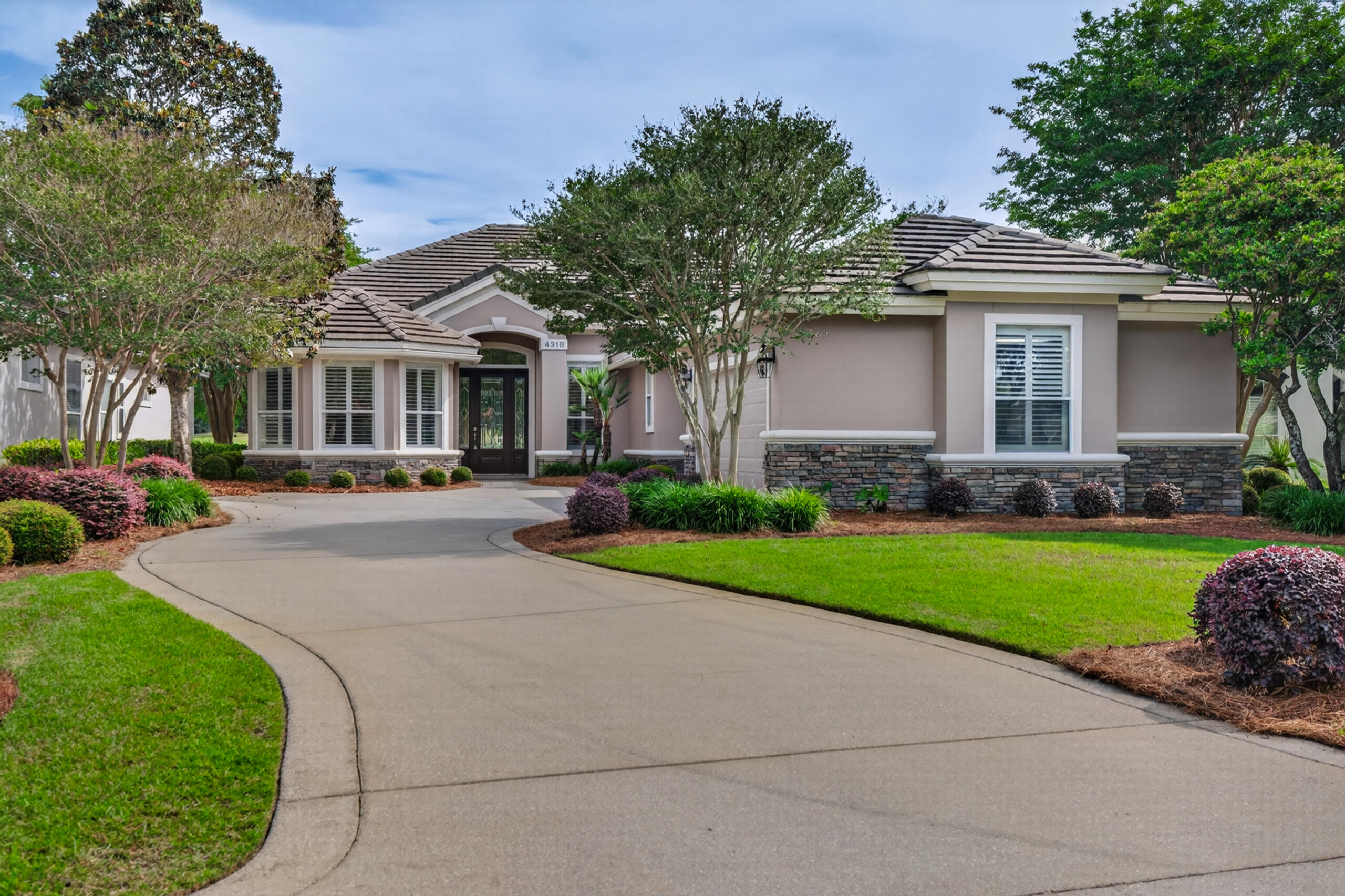 Nestled within the highly sought-after community of Kelly Plantation, this beautifully maintained home in Carriage Place offers breathtaking waterfront views of both the lake and the 14th hole on the golf course. Ideally located near the sugar-white sands and crystalline-green waters of the Emerald Coast, the property also provides convenient access to premier shopping, dining, and local amenities.

The home features a meticulously landscaped yard with mature greenery, creating a welcoming and serene curb appeal. For golf enthusiasts, the garage includes a dedicated enclosed space for a golf cart. Recent updates-including fresh paint, modern lighting, and structural enhancements-make this home perfect for both everyday living and entertaining. The spacious kitchen is a standout, showcasing custom wood cabinetry, granite countertops, under counter lighting, and abundant storage. A long countertop provides the perfect space for buffets or displaying small appliances, while a separate nook is ideal for a coffee bar. The open-concept layout flows seamlessly into the family room, creating a warm and inviting gathering space. Sliding glass doors lead to a large screened-in lanai, extending your entertaining area outdoors. The lanai is accessible from both the main living areas and the primary suite.

The family room is designed to accommodate a large-screen TV, easily visible from the kitchen for effortless entertaining. There are speakers for great sound in the family room, the lanai, the living area and the master bedroom. The primary suite features a tray ceiling, private access to the lanai, and ample space for king-sized furnishings. Dual closets provide generous storage, while the ensuite bathroom includes under cabinet lighting, a walk-in shower, soaking tub, and a separate water closet for added privacy.

At the front of the home, a sunlit room with expansive windows and built-in bookcase offers a perfect setting for a home or reading retreat. The built-in features 4 large file drawers and ample storage for a home office. The additional bedrooms are generously sized, providing comfort and flexibility for family or guests.

Pride of ownership is evident throughout this meticulously cared-for property. Residents of Kelly Plantation enjoy a wide array of community amenities, enhancing both lifestyle and convenience.
Buyers to verify all lot and home dimensions. The listing is enhanced with AI furnishings, but the home is being sold unfurnished. The small accessories are property of the realtor but can be purchased outside closing. Buyers to verify all lot and home dimensions. The seller is offering a home warranty from Assurant