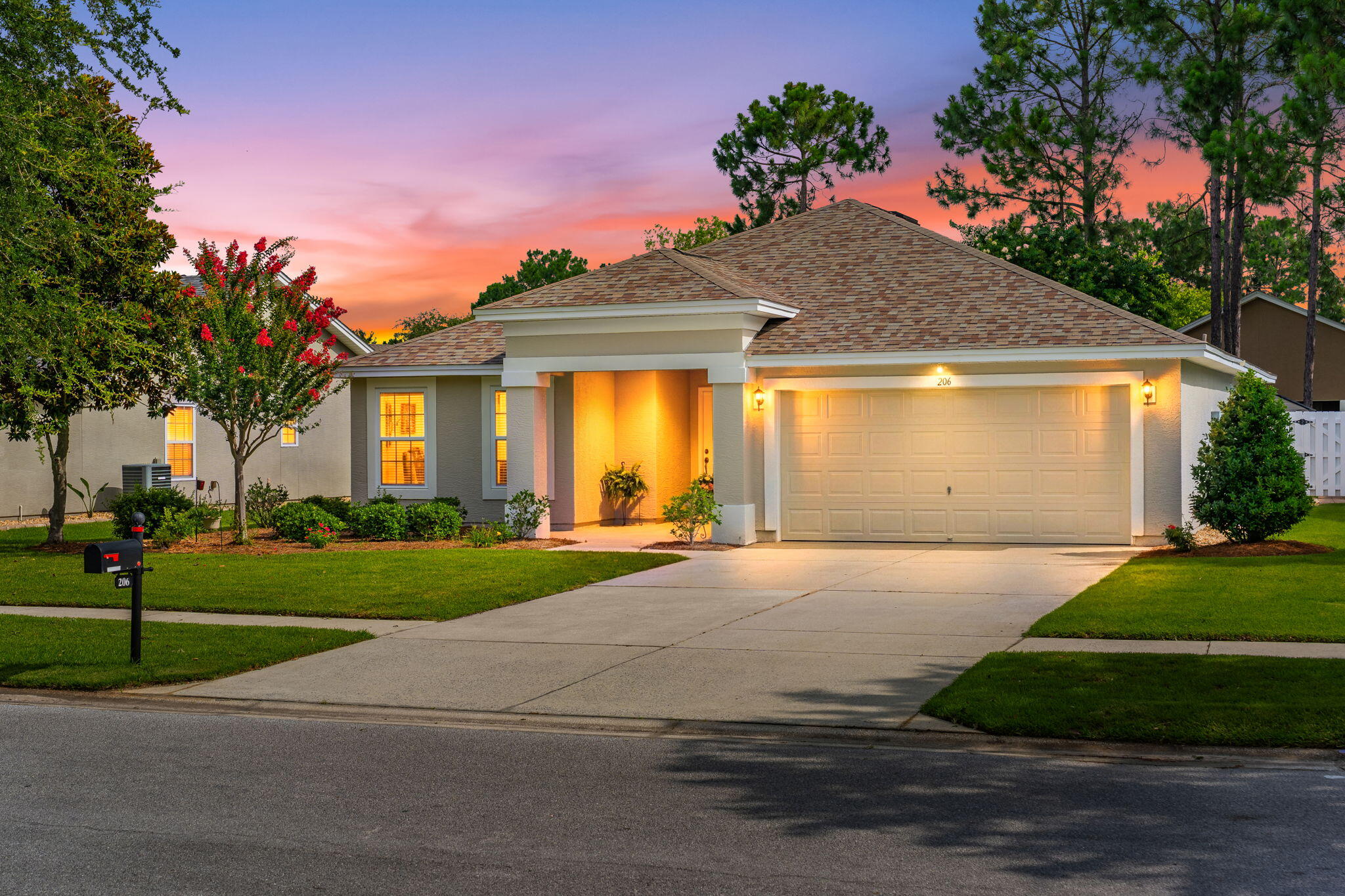 Welcome to Palmetto Trace, a golf cart-friendly community offering convenient access to Pier Park, Frank Brown Park, and the white sand beaches of Panama City Beach. Residents enjoy sidewalks throughout the neighborhood, flowering trees, pet-friendly walking areas, two community pools, low quarterly HOA dues, and garbage service provided by the HOA. This well-maintained home features a split-bedroom floor plan with spacious bedrooms and an inviting layout. The kitchen offers a large pantry, newer appliances, and a sunny breakfast nook overlooking the peaceful backyard where mature flowering trees create a beautiful setting throughout the seasons. Step outside to the screened porch, an ideal place to enjoy Florida's outdoor lifestyle while taking in the backyard views and local wildlife. The oversized two-car garage provides ample space for vehicles and additional storage. Recent updates include a roof installed in December 2018 with a 40-year shingle, a water heater replaced in June 2023, and a freshly painted exterior. Pride of ownership is evident throughout this exceptionally cared-for home, offering a move-in ready opportunity in one of Panama City Beach's most desirable communities.
