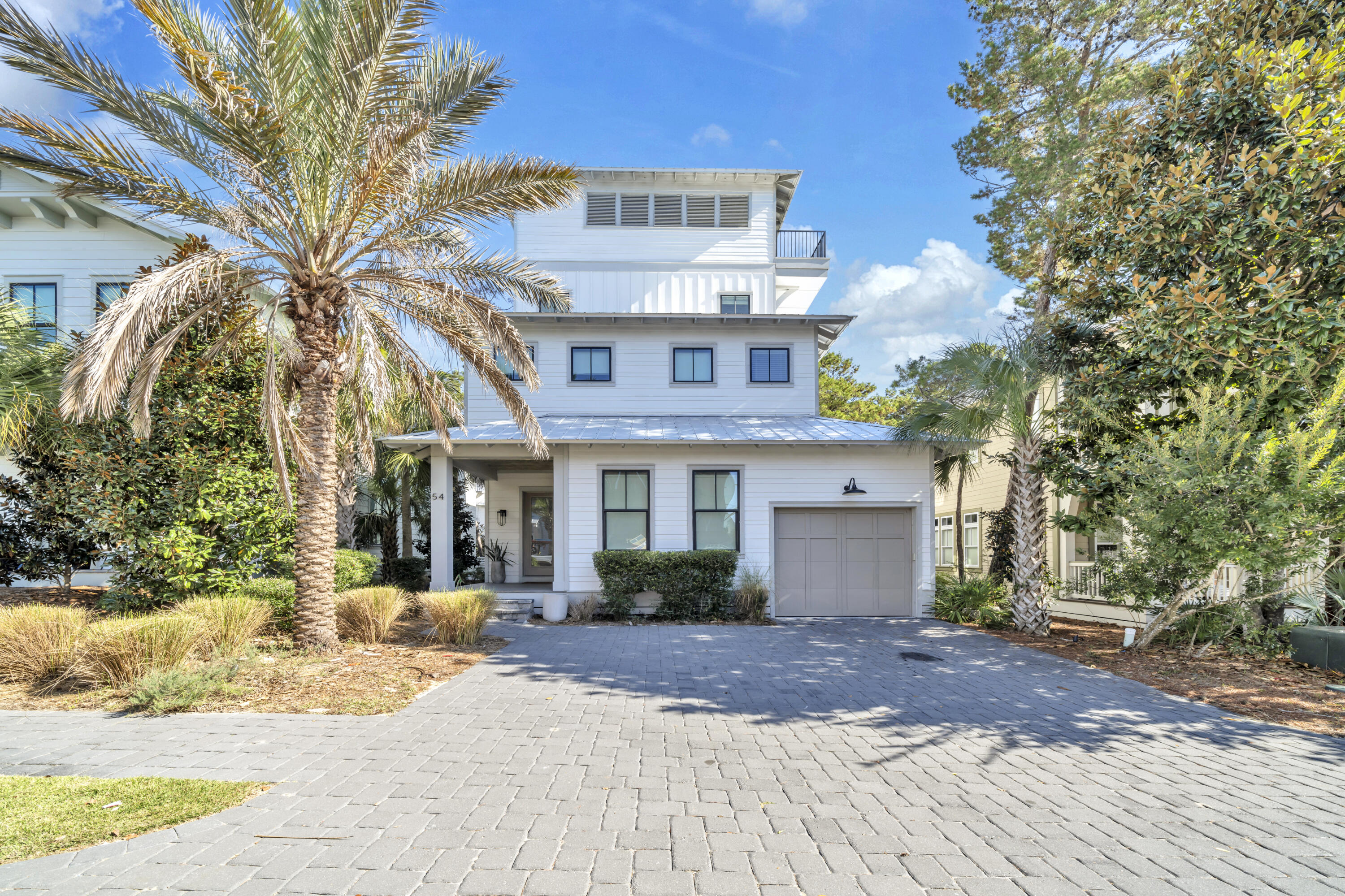 STUNNING VIEWS... striking four-level coastal retreat elevates the art of relaxed luxury with thoughtful design and effortless livability just moments from the gulf. A short walk to the shore places you in vacation mode immediately, while the iconic 30A corridor sits only a stone's throw away for dining, shopping, and endless coastal experiences. Inside, the home -- a 2022 build -- unfolds with polished ease, beginning with an open-concept first floor wrapped in hardwood floors, Venetian plaster, and warm stained wood ceilings that add depth and artistry to each gathering space. An entire level is devoted to entertainment, offering a generous lounge anchored by a pool table, wet bar, and built-in conveniences ideal for unwinding after a sun-soaked day. Continue upward to the rooftop deck  incredible gulf views extend the experience and provide a serene perch for morning coffee or sunset conversations. Every floor is designed for comfort, including four bedrooms with private or nearby baths, two king ensuites, a queen ensuite, and a well-appointed bunk room that transforms the home into a welcoming haven for up to 10 guests. This fully furnished residence has been professionally outfitted to function beautifully as a vacation home or investment property. Owners and guests enjoy access to a community pool, gathering room, and a dock on Lake Powell for paddleboarding, kayaking, and quiet mornings on the water. With its rare combination of upscale finishes, thoughtful amenities, and rooftop gulf vistas, this home offers a coastal escape that draws you back year after year.