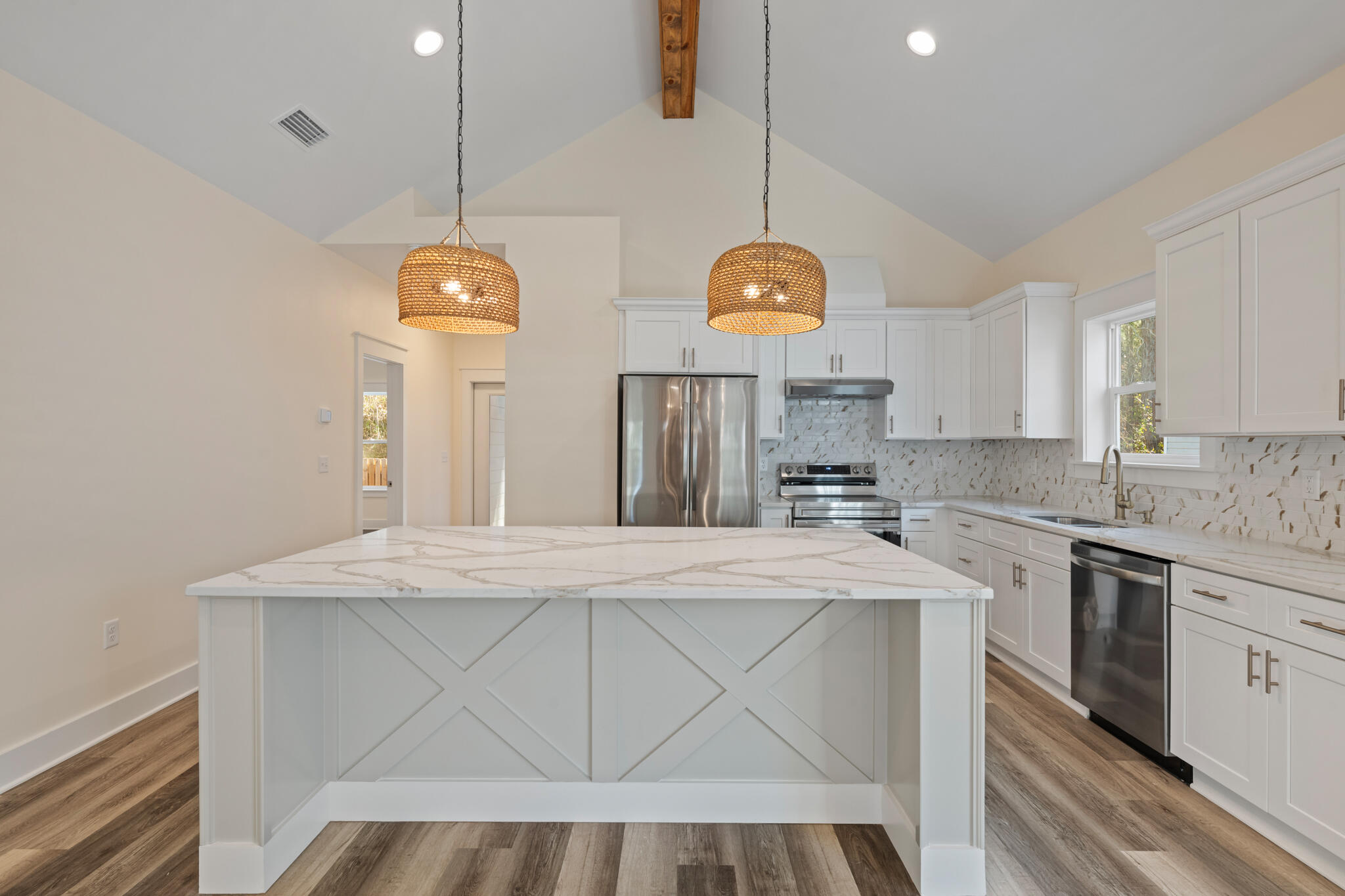 No HOA! Experience investment and relaxing coastal living in this brand-new beach home! Perfectly positioned near Choctawhatchee Bay and the pristine white sands of the Emerald Coast. Just moments from boating access at Cessna Landing and minutes from the Gulf, this New Built, offers an exceptional balance of luxury, lifestyle, and location.
The interior is thoughtfully curated with vaulted ceilings, exposed wood beams, and an open-concept design that seamlessly connects the living, dining, and kitchen spaces. The chef-inspired kitchen features quartz countertops and soft-close cabinetry, while the living room invites relaxation with a warm fireplace and inviting coastal ambiance.