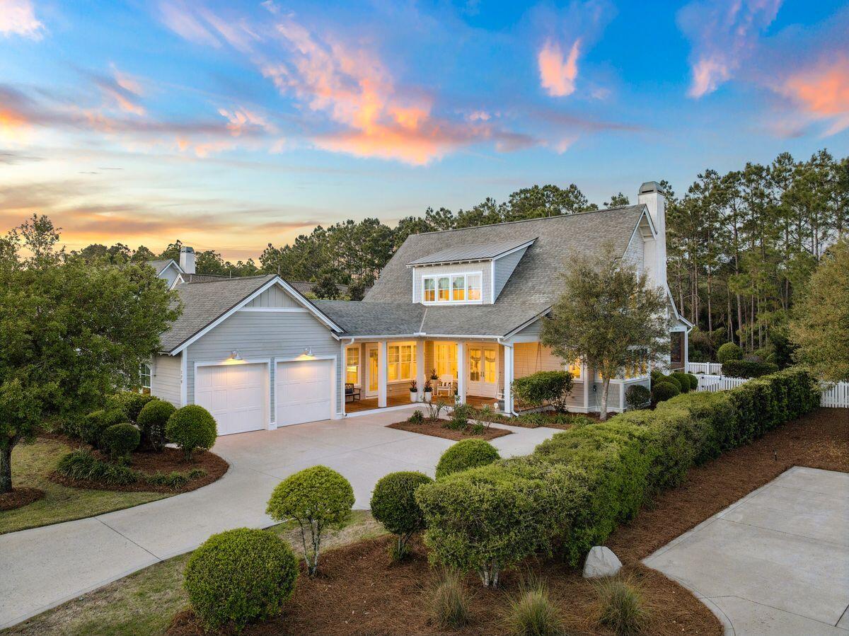 Located in the established area of WaterSound Origins, this highly sought-after Weatherly floor plan by Romair Homes sits on an exceptionally private homesite backing to a serene nature preserve. This Cape Cod-inspired home offers 4 bedrooms plus bunks, 4.5 baths, including a primary suite on the main level, combining timeless design with everyday functionality.
You are welcomed by a charming front porch complete with a quintessential porch swing, setting the tone for relaxed coastal living. Offered fully furnished, this home presents a turnkey opportunity for buyers, adding immediate value and ease of ownership. Convenient access via Breaker Street makes getting in and out of the community effortless. Situated on the south side of Splash Drive, this section of WaterSound Origins is known for its generous spacing, creating a uniquely quiet and private setting.
The main living area features an open floor plan ideal for both everyday living and entertaining, with seamless flow between the kitchen, dining, and living spaces. Upstairs, in addition to three bedrooms, you will find a secondary living area or study, along with a separate built-in bunk space, offering flexible accommodations for guests and family.
Outdoor living is a true highlight, creating a private oasis. The oversized backyard features a heated saltwater pool and spa, along with an outdoor fireplace and cabana, all backing to protected green space for an unmatched sense of privacy. A spacious screened porch and mature landscaping further enhance the natural, tranquil setting.
This is one of the most beloved floor plans in WaterSound Origins, offering a rare combination of privacy, thoughtful design, and timeless coastal charm.