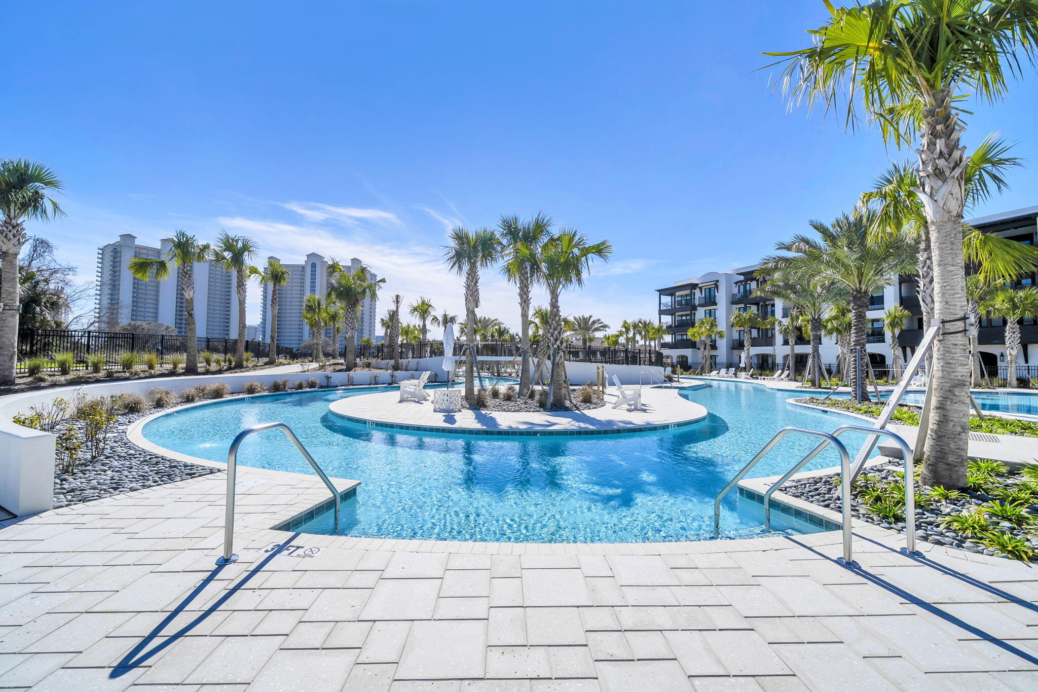 Welcome to luxury coastal living at its finest! This brand new construction condo offers nearly 2,400 square feet of thoughtfully designed space, featuring 4 spacious bedrooms and 4.5 baths, each bedroom with its own private ensuite for ultimate comfort and privacy.

Step inside to find 9 foot ceilings, luxury vinyl plank flooring, quartz countertops, soft close cabinetry, gas range, and high end Bosch appliances throughout the kitchen. Designer touches like decorative barn doors add character, oversized closets, abundant storage included. The unit comes fully furnished and includes a washer and dryer, making it truly turnkey.

Enjoy seamless indoor outdoor living with an oversized balcony overlooking the stunning tropical pools, lazy river, and swaying palm trees. Ideally located right next to the pool, this condo offers one of the best spots in the community.   The Mediterranean style building features elevators for convenience, along with beautifully designed pavilions complete with glass fireplaces, gas grills, and inviting lounge and picnic areas. Cocktails and food service at the pool, launching this summer.  Short term rentals are allowed.  Owners and guests enjoy access to all the amenities at The Grove and Seascape Resort, including golf, tennis, pickleball, and 2,000 feet of pristine beach.  Many restaurants onsite including 2 Birds, ACME Oyster House, Mezcal and the popular beach front Whale's Tail  restaurant.