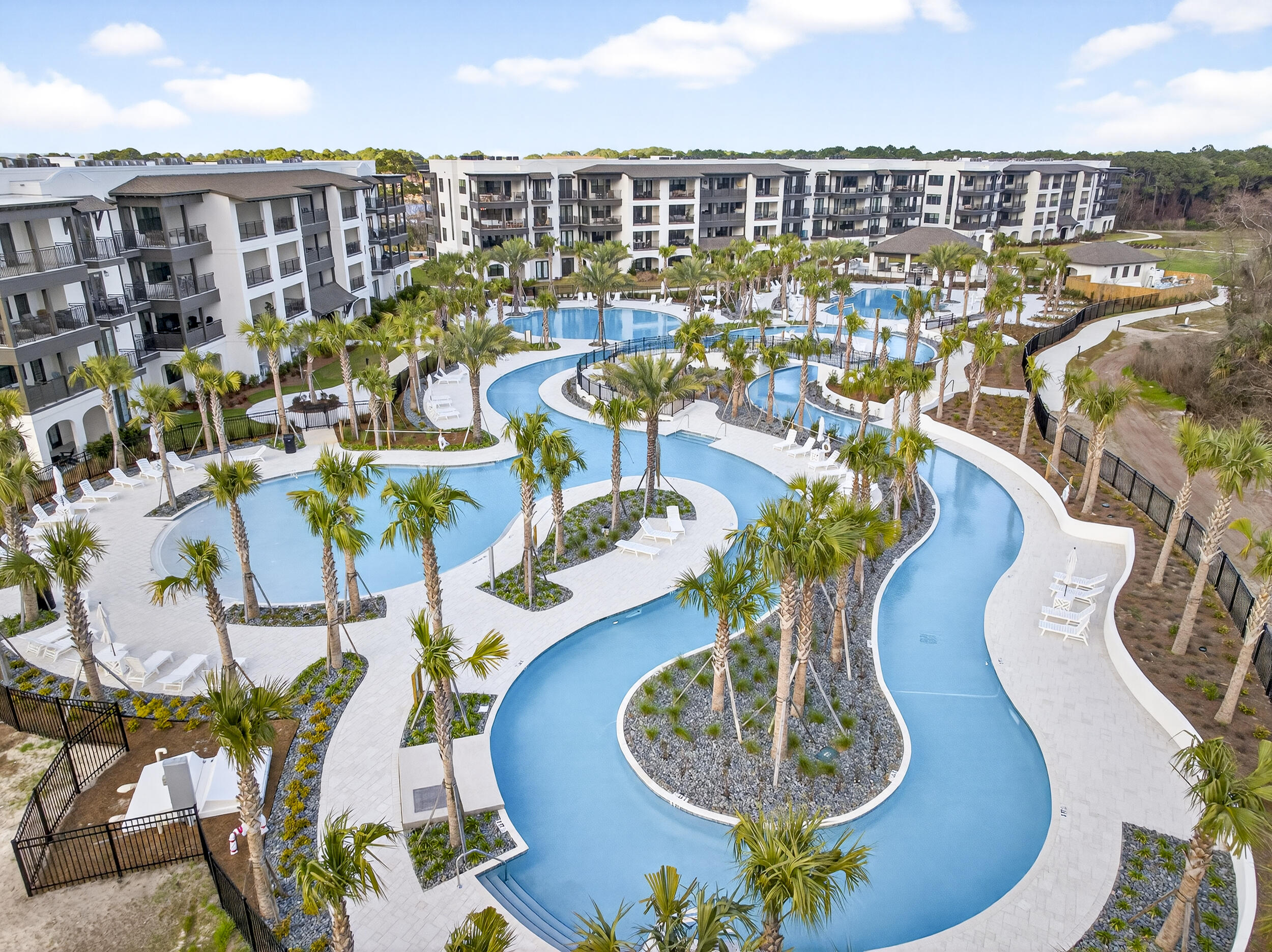 Welcome to luxury coastal living at its finest! This brand new construction condo offers nearly 2,400 square feet of thoughtfully designed space, featuring 4 spacious bedrooms and 4.5 baths, each bedroom with its own private ensuite for ultimate comfort and privacy.

Step inside to find 9 foot ceilings, luxury vinyl plank flooring, quartz countertops, soft close cabinetry, gas range, and high end Bosch appliances throughout the kitchen. Designer touches like decorative barn doors add character, oversized closets, abundant storage included. The unit comes fully furnished and includes a washer and dryer, making it truly turnkey.

Enjoy seamless indoor outdoor living with an oversized balcony overlooking the stunning tropical pools, lazy river, and swaying palm trees. Ideally located right next to the pool, this condo offers one of the best spots in the community.   The Mediterranean style building features elevators for convenience, along with beautifully designed pavilions complete with glass fireplaces, gas grills, and inviting lounge and picnic areas. Cocktails and food service at the pool, launching this summer.  Short term rentals are allowed.  Owners and guests enjoy access to all the amenities at The Grove and Seascape Resort, including golf, tennis, pickleball, and 2,000 feet of pristine beach.  Many restaurants onsite including 2 Birds, ACME Oyster House, Mezcal and the popular beach front Whale's Tail  restaurant.