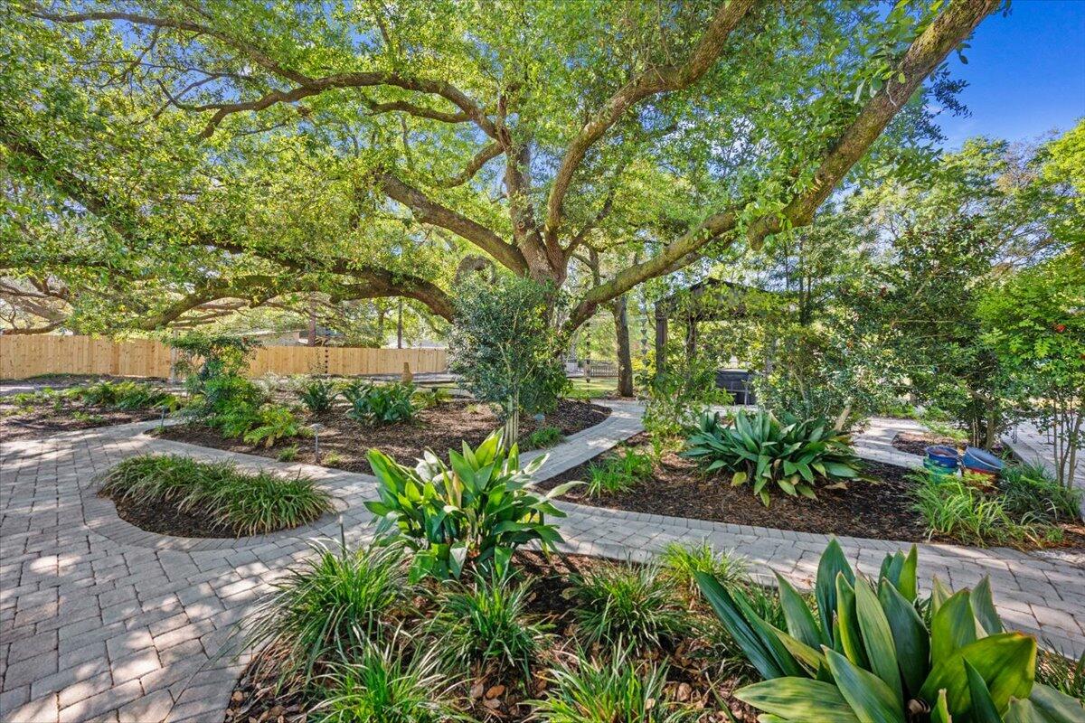 This beautifully designed 2023 barndominium offers a unique, specialty-crafted interior with a stunning, cohesive color palette throughout. The open-concept kitchen flows seamlessly into the living space, creating a warm and inviting atmosphere. Spacious bedrooms are filled with natural light, enhancing comfort and charm. Step outside to a private, garden-like retreat featuring majestic oak trees, custom paver walkways, and a cozy outdoor fireplace. Additional features include a storage shed and a newer hot tub. Conveniently located just five minutes from a boat ramp, this home blends style, tranquility, and accessibility.