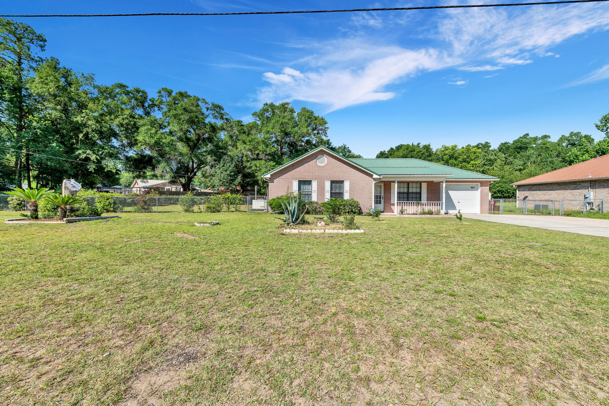 THIS PROPERTY IS SO VERSATILE AND HAS BEEN CARED FOR WITH LOVE.  WITH SO MANY UPDATES INCLUDING HVAC, HOT WATER HEATER, ROOF (WITHIN 7 YRS), FLOORING, MASTER SHOWER, OPEN KITCHEN/LIVING AREA AND NEW APPLIANCES IN THE KITCHEN, ITS JUST WAITING ON FINISHING TOUCHES FROM A NEW BUYER.  THIS PROPERTY SITS ON .36 ACRE LOT IN  NORTH CRESTVIEW WITH MANY FRUIT TREES AND GARDENS IN THE YARD.  THERE IS PLENTY SPACE IN BACK FOR PUTTING IN A POOL.   A BEAUTIFUL FLORIDA ROOM ADDS SO MUCH SPACE  TO  ENJOY WITH FRIENDS AND FAMILY AND LEADS TO THE PRIVATE FENCED  BACK YARD WITH CUTE SITTING AREAS AND A FIREPIT.   THE HOUSE HAS A ONE YEAR OLD GENERAC GENERATOR THAT COMES WITH A TRANSFERRABLE 5 YEAR WARRANTY AND A TRANSFERABLE ADT SECURITY SYSTEM.  THE SPACOUS SHED COMES COMPLETE WITH SOME TOOLS INCLUDED FOR NEW BUYER'S LAWN CARE NEEDS.   INSIDE YOU ARE GREETED BY A COMFORTABLE LIVING AREA WITH AMPLE NATURAL LIGHT THAT OPENS UP TO THE UPDATED KITCHEN WHICH FEATURES A NEW GAS STOVE AND NEW REFRIGERATOR.  FANS THROUGHOUT THE ENTIRE HOUSE HELP KEEP THE COOLING COSTS DOWN.   THE MASTER BEDROOM INCLUDES A UPDATED BATHROOM.  THIS HOME PROVIDES COMFORT, FUNCTIONALITY, NO HOA, AND PLENTY OF OUTDOOR SPACE AS WELL TO ENJOY.  COME CHECK IT OUT, WITH SO MANY ADDITIONAL FEATURES YOU TRULY NEED TO SEE IT AND MAKE IT YOUR OWN BEAUTIFUL OASIS!  SELLER WILL KICK IN $5000 TOWARD BUYERS CLOSING COST - A RARE PROPERTY WAITING ON ITS NEW BUYER!