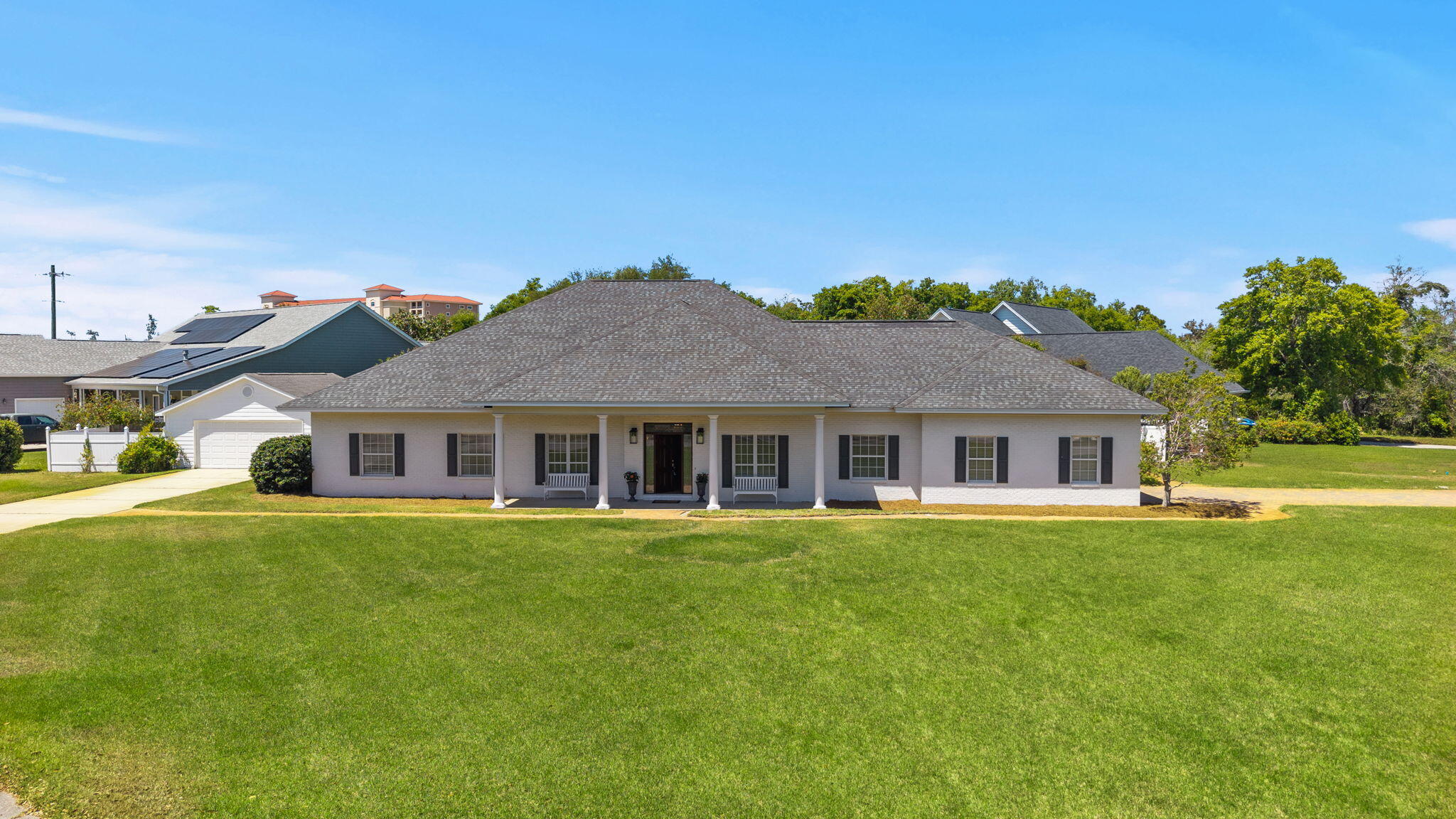 This is where square footage, functionality, and coastal convenience come together in one exceptional Panama City Beach home. Offering a stunning corner .46-acre homesite, mainly single level floorplan, 4-car garage and no HOA, this home is located just minutes from the sugar white sandy beaches and allows you to live the Florida lifestyle immediately. 

Spanning an impressive 4,079 square feet, this thoughtfully-designed residence offers 4 oversized bedrooms, a dedicated home office, sitting room, formal dining room, and a stunning vaulted living room that creates an open, airy feel from the moment you walk in. The eat-in kitchen flows seamlessly into the main living spaces, making it ideal for both everyday living and entertaining. The covered, screened-in back porch make enjoying the outdoors year-round possible and the back yard provides room for a future private pool. The primary suite is located on the main level and serves as a true retreat, complete with French doors leading to the backyard, a soaking tub, separate tiled shower, and a spacious walk-in closet. Every bedroom throughout the home features generous proportions and 10-foot ceilings, providing comfort and flexibility. 

All bedrooms in this home are on the main level and upstairs, an expansive bonus room with a powder bath offers endless possibilities...perfect for a game room, playroom, media space, man cave, or even a fifth bedroom, if desired. Designed with convenience in mind, the home includes an oversized laundry and mudroom, wide hallways, and a rare 4-car garage, including one drive-through bay...ideal for storing boats, golf carts, or additional vehicles. 

A whole-home generator also adds peace of mind year-round. Situated on a desirable corner homesite, the property features a large covered front porch, a spacious screened-in back porch, and ample room to design your dream pool and outdoor oasis. With no HOA and a well-maintained neighborhood, you'll enjoy both freedom and pride of ownership. 

Situated just outside of the Bay Point and Preserve communities, you're going to love the East end of Panama City Beach. The Bay Point community offers an incredible golf experience and marina to host your boat year-round. St. Andrews State Park is just right around the corner as well as access to marinas, waterfront dining and more. Located just minutes from dining, shopping and a nearby public boat ramp, this home offers the perfect balance of privacy, space, and allows you to live the way you want to in Florida!