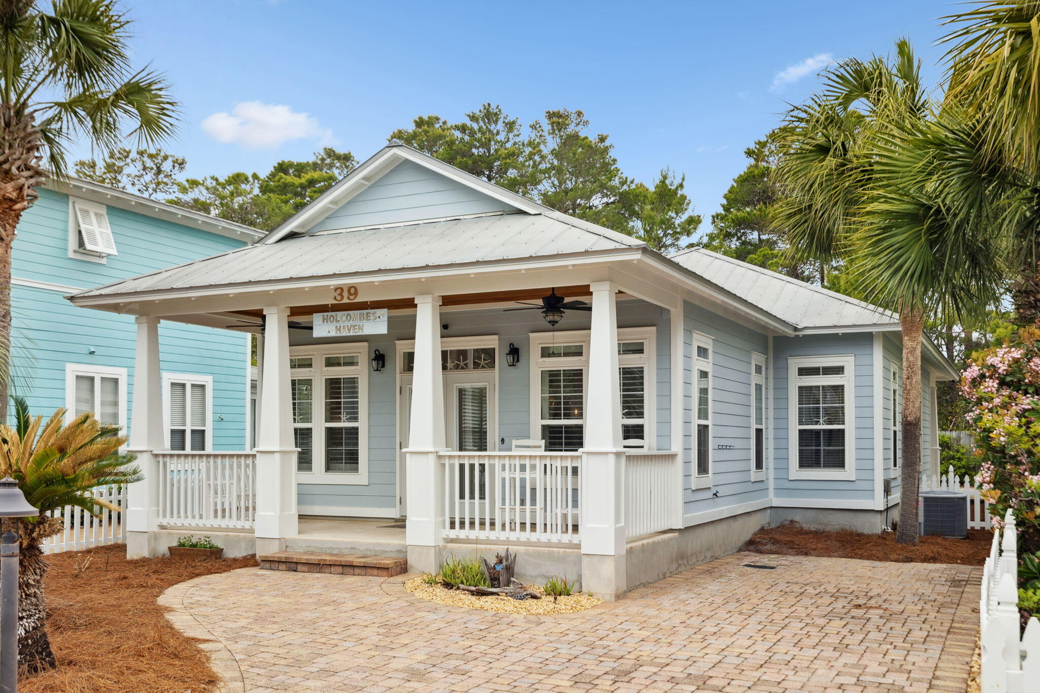 Nestled in a peaceful cul-de-sac, this charming beach cottage offers the perfect blend of coastal charm and modern convenience. Just minutes from the beach, this single-story, 3-bedroom, 2-bathroom home is an excellent choice for a full-time residence, vacation retreat, or investment property.

A welcoming front porch invites you inside, where an open-concept living, dining, and kitchen area creates a warm and inviting atmosphere. The kitchen is beautifully updated with stainless steel appliances, freshly painted white cabinetry, new elegant quartz countertops, and new light fixtures that add a modern touch to the space. The spacious primary suite is designed for relaxation, featuring a private en-suite bath and a generous walk-in closet with upgraded custom shelving. Large windows allow natural light to fill the space, while plantation shutters provide privacy and a touch of coastal elegance. The en-suite bath includes a new quartz-topped vanity, a glass-enclosed tub, and stylish tile flooring for a spa-like feel.

Two well-appointed secondary bedrooms provide comfortable accommodations for family and guests. Both rooms feature ample closet space, natural light, and new light fixtures for a fresh, modern look. They share a beautifully updated bathroom with tile flooring, new quartz countertops, and a sleek glass tub enclosure.

Additional highlights include Travertine flooring throughout, custom wooden closet shelving, and surround sound audio connections. Thoughtful upgrades enhance comfort and efficiency, such as a sprinkler system, sink disposal, a filtered water faucet in the kitchen, custom closet systems, plantation shutters in the main living area and primary bedroom, plumbing for a Culligan water purification system, a drip irrigation system, a water pressure regulator, and an energy-efficient Carrier air/heat pump. Invisiguard window film adds an extra layer of comfort and energy savings.