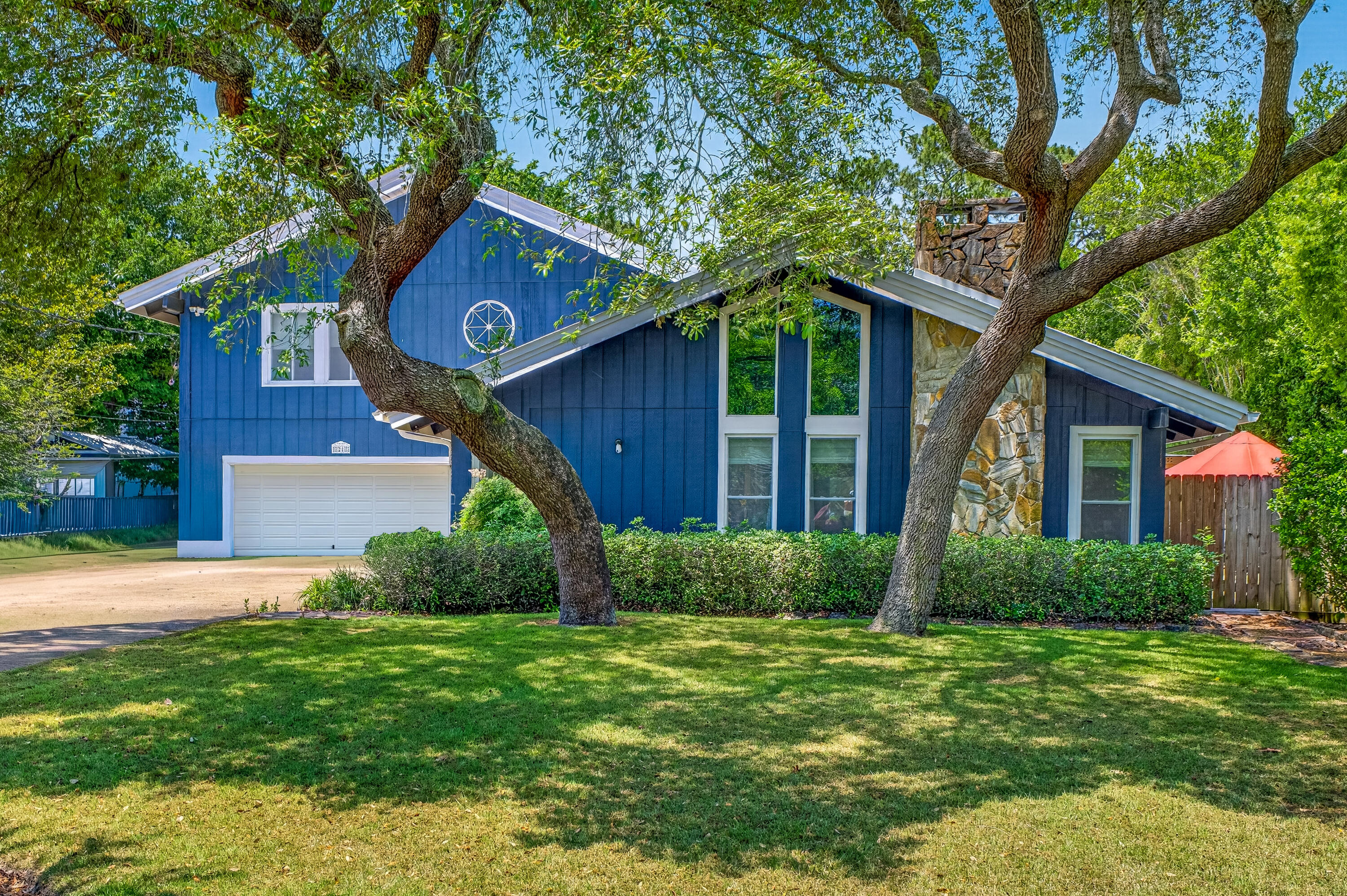 This timeless Craftsman-style home is a rare opportunity to own a property that seldom hits the market. No HOA
Situated on a generous half-acre lot (slightly under) in the highly desirable neighborhood of Kenwood.  
Featuring two stories with vaulted ceilings, natural wood beams, crown molding, and oversized windows allowing natural light in for a fresh, open feel.

Completely updated, New Roof 2021,
HVAC 2021, HWH 2021, Pool liner 2025, 50amp RV hookup, Irrigation system with Wi-Fi timer and private well, double gate with additional parking pad.

Upon entering, there are expansive windows with motorized blinds, cozy seating areas, and an inviting dining area. The centerpiece of the living room features a floor-to-ceiling flagstone fireplace framed by a custom mantle, travertine tile in the entryway, and a tile floor that flows throughout.
Stylishly updated kitchen highlights quartz countertops, a breakfast bar and island, modern ceiling tiles, stainless-steel appliances, and a convenient pantry.
Spacious main-level bedroom suite decorated with ship lap walls, indoor-outdoor access to Florida room, and an adjoining custom spa-like bathroom, complemented by a his-and-her quartz double vanity, oversized closets, cultured marble shower with dual showerheads, and bath heat feature. A separate bonus room provides extra space for everyday living. 
Additional first-floor living space includes an enclosed, heated, and cooled Florida room overlooking the spacious resort-style backyard The upstairs stairway provides access to a loft-style landing area connecting two oversized bedrooms with vaulted ceilings, large closets, and an additional bonus room with endless possibilities for work, play, or relaxation. The upstairs full bathroom has a tiled shower-tub combo, a new vanity, and a Bluetooth fixture. This home includes a spacious upstairs walk-in attic, accessible from the loft.
Step outside to a one-of-a-kind Resort-inspired backyard oasis with multiple entertainment zones, mature trees, zoysia grass, pristine landscape, and backyard paver hardscape, enhanced by an additional pergola with evening lighting. Relax by the stunning 16x32 in-ground (8ft deep) saltwater swimming pool (not heated), featuring a new pool liner, salt cell, new motor, sand filter, and robotic cleaner. Sit by the fire pit, watch TV, or entertain under the stars in an illuminated 20x20 custom Gazebo. 
A 12x24 shed equipped with electric and a large roll-up entry door, and a plastic yard shed provides extra workspace or storage.
Crafted for the ultimate backyard lifestyle and outdoor entertaining aficionados, the custom-built, band-inspired Pool Bar features a 15x13 covered deck, perfect for entertaining guests. Inside, you can cool off with air conditioning, play darts, and have a cold drink from the bar, with a convenient free-standing ice maker and refrigerator.