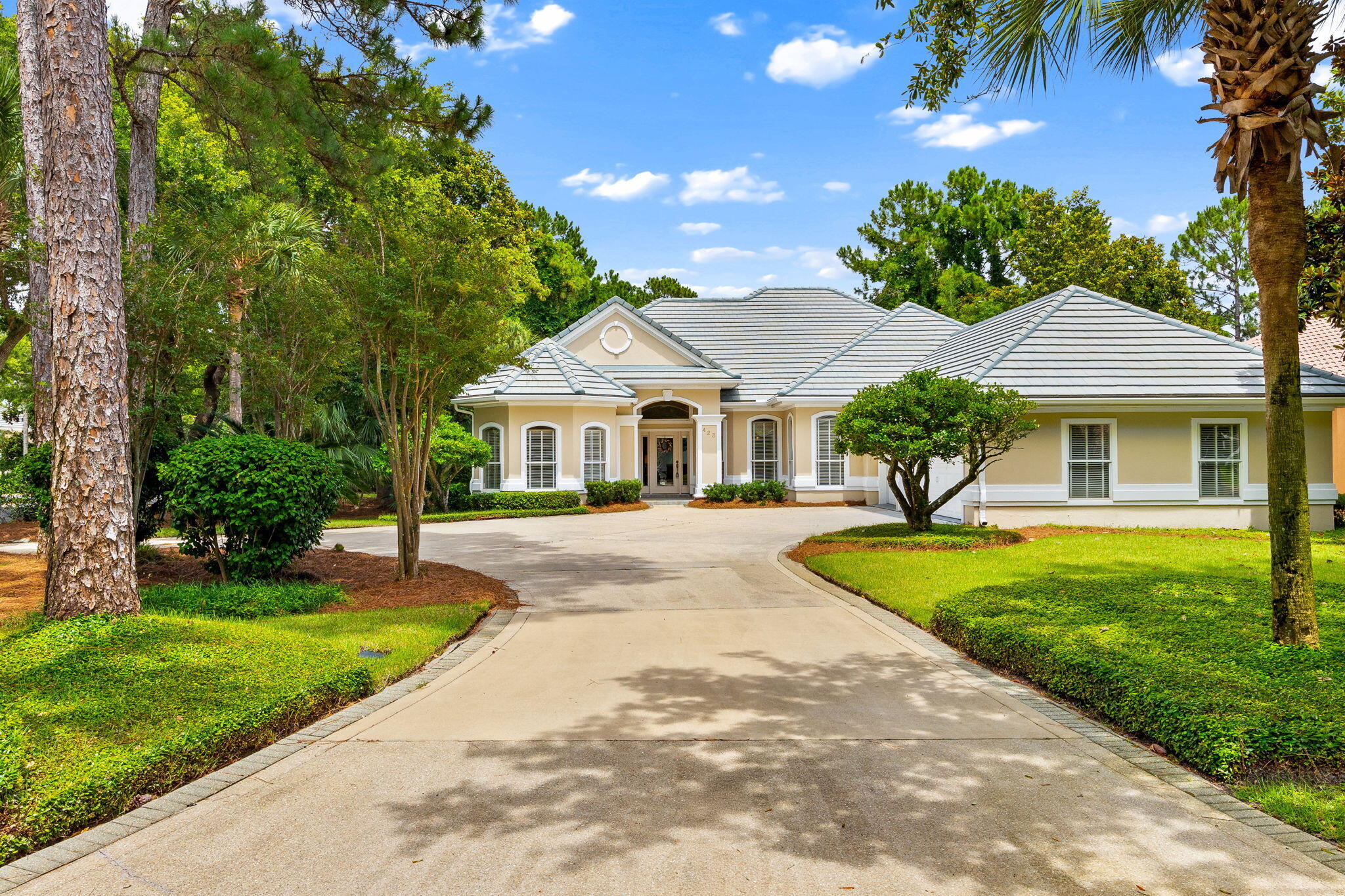 Experience resort-style living in the highly sought-after Regatta Bay community, one of Destin's premier gated neighborhoods. Perfectly positioned on a quiet, tree-lined street with a serene lake backdrop, this impeccably maintained, one-owner home offers the ideal blend of luxury, comfort, and privacy.

Featuring over 2,600 square feet of thoughtfully designed living space, the home includes three spacious bedrooms, three full bathrooms, and an open-concept layout that feels both expansive and inviting. The gourmet kitchen seamlessly connects to the living and dining areas, creating an ideal setting for everyday living and entertaining. A gas fireplace adds warmth and character to the main living space, while large windows showcase views of the private backyard retreat.

Step outside to your covered lanai complete with a built-in gas grill, overlooking the screened pool and hot tub. Whether hosting guests or enjoying a quiet evening at home, this outdoor oasis provides year-round enjoyment.

The spacious primary suite serves as a private sanctuary, offering direct access to the pool area, a comfortable sitting area, and an elegant tray ceiling. The luxurious ensuite bathroom features dual vanities, a large jetted soaking tub, and a separate walk-in shower.

Additional highlights include a two-car garage plus a dedicated third bay for a golf cart, perfect for enjoying the community's golf cart-friendly lifestyle. Residents of Regatta Bay enjoy an exceptional array of amenities, including a championship golf course, tennis courts, swimming pools, playgrounds, walking trails, and a private marina. Conveniently located just minutes from the beach, Choctawhatchee Bay, premier shopping, dining, and entertainment, this home offers the very best of the Emerald Coast lifestyle.

Whether you're searching for a full-time residence, second home, or coastal retreat, this exceptional property presents a rare opportunity to enjoy luxury living in one of Destin's most desirable communities.