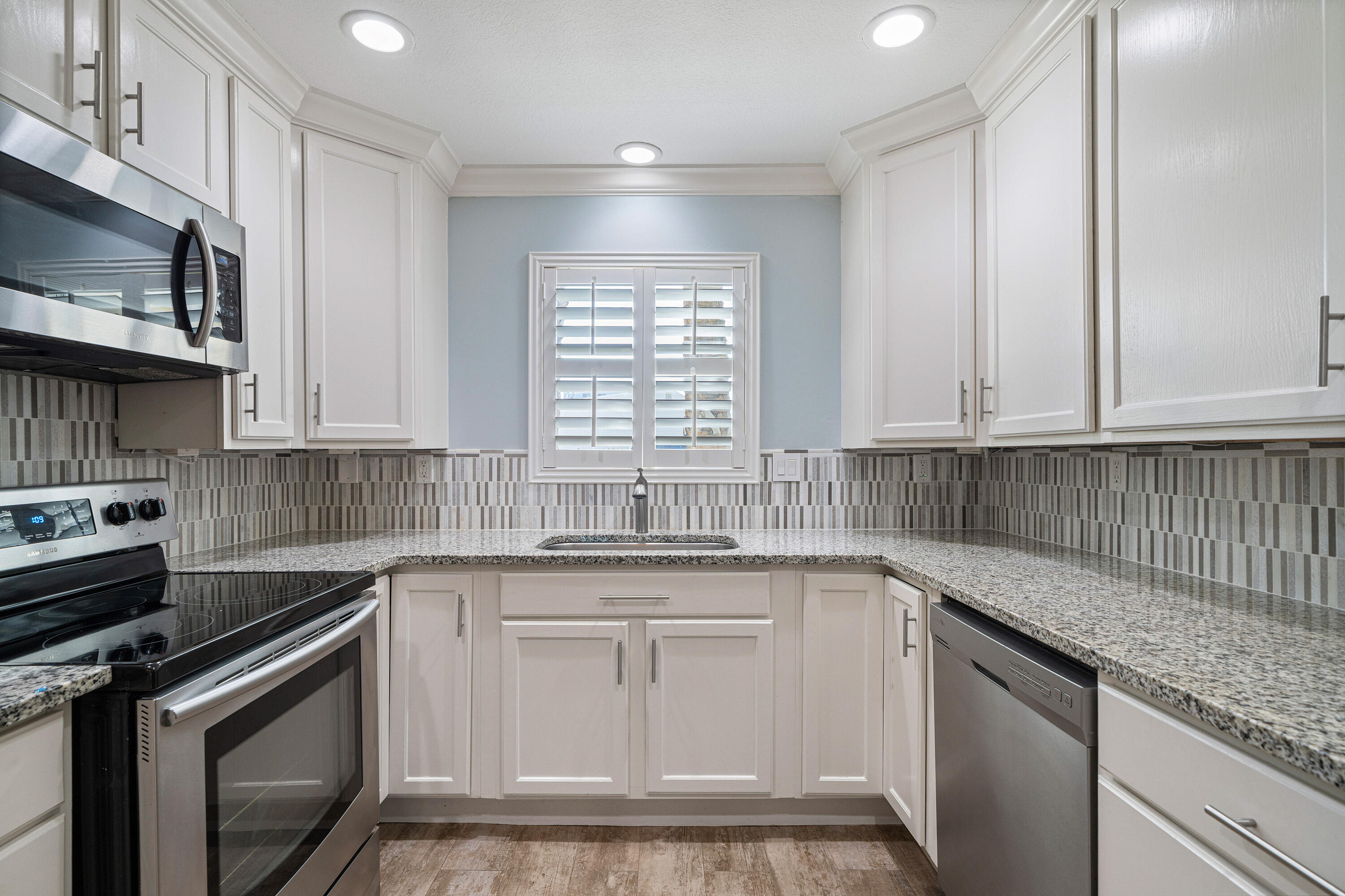 Move in ready and completely turnkey, this updated and spacious townhome offers an unbeatable location, just blocks from HarborWalk Village and minutes to the beaches. Walk or bike to some of Destin's favorite spots, including the Destin Harbor with plenty of waterfront dining and entertainment, the Destin Brewery, McGuire's, Boshamps, and East Pass Coffee - just to name a few. Enjoy the benefit of a 1 car garage, providing covered parking and room for beach gear or bikes. Inside, you'll find wood look tile flowing throughout the home. The kitchen features granite countertops, stainless steel appliances, and generous cabinet and counter space. Crown molding, recessed lighting, and plantation shutters add custom touches throughout. All bathrooms have been updated with tile and modern vanities. The oversized master bedroom features vaulted ceilings, and the master bath includes a tiled shower with a glass enclosure. A washer and dryer are conveniently located upstairs just outside the master bedroom and convey with the home. There is abundant storage throughout, with plenty of closet space, including extra storage under the stairs. Step outside in the back to enjoy the HOA maintained green space for easy, low-maintenance living. Don't miss this opportunity to own a townhome with a low HOA, in the heart of Destin...just minutes from everything the area has to offer!