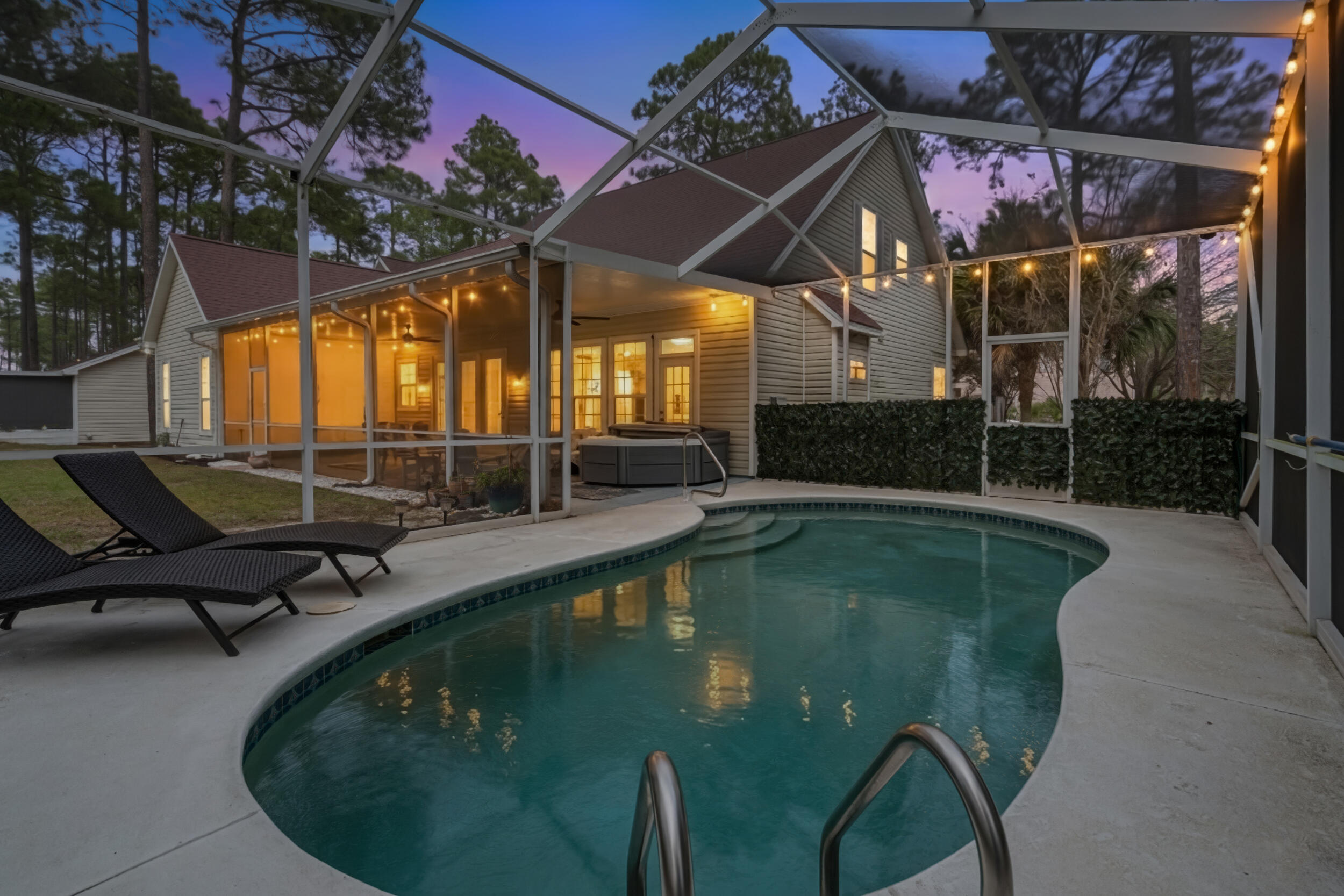 Welcome to a private coastal retreat offering EXCEPTIONAL flexibility, space, and lifestyle just minutes from the white sand beaches of Scenic Highway 30A!

Situated on 1.10 acres along the quiet private road of Hamon Haven, this unique property functions like THREE homes in one, providing multiple living areas ideal for multigenerational living, hosting guests, creative workspaces, or extended stays!

The main residence features spacious living areas, a large custom kitchen island, generous pantry storage, and multiple flexible-use rooms that have previously accommodated large gatherings and overnight guests. Thoughtful layout options allow portions of the home to be connected OR privately separated, creating opportunities for a primary residence, guest wing, or additional living quarters.

An additional studio-style den living space with private entrance offers a mini kitchen, pantry storage, and heating and cooling--perfect for guests, a home office, playroom, or creative studio. The attached casita includes its own kitchen area, laundry, and ample storage, making it ideal for extended family or private guest accommodations.

Designed for both comfort and entertaining, the outdoor space is a true highlight of the property. Enjoy a heated pool, two hot tubs, outdoor showers, fire pit, and expansive wooded surroundings with walking trails and mature Florida orange citrus trees. The one-acre setting provides privacy RARELY found this close to the beach! 
Additional features include:
Heated pool with propane system
Outdoor entertaining areas and BBQ space
Workshop/storage shed with power and 220 outlet
Private well and septic system
Whole-home generator capability
Two HVAC systems in the main home
Smart home controls including Nest system
Extensive storage throughout the property
Located just minutes from the beaches of 30A, Grayton Beach, and local dining and shopping, this property offers the perfect blend of privacy, flexibility, and coastal living.

Whether you're searching for a private family compound, a multigenerational retreat, or a unique coastal property with flexible living spaces, this home offers a rare opportunity in one of South Walton's most desirable areas.