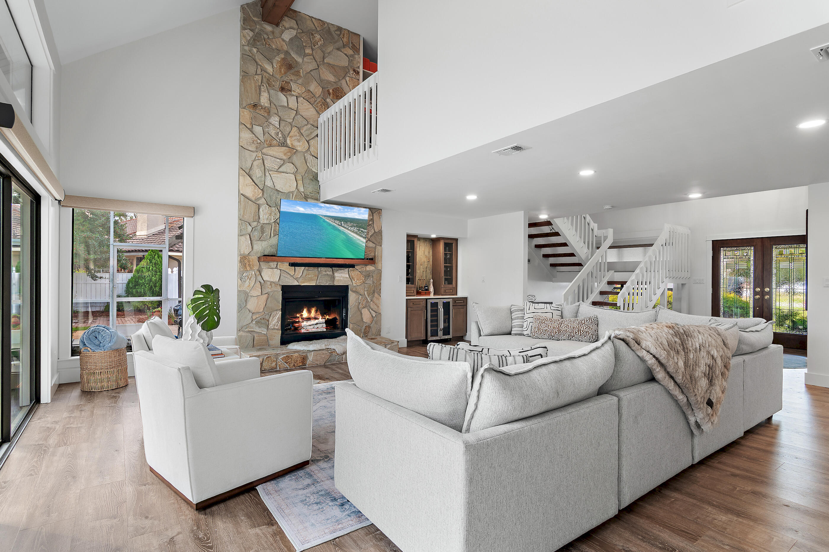 Welcome to 99 Country Club Dr. W, an elegantly updated contemporary home situated on a rare half-acre golf course lot in the sought-after Indian Bayou community in Destin Proper. This striking white-brick home offers 3479 sq. ft. of heated and cooled living space and showcases modern updates and designer finishes throughout. The first floor features a private master suite along with a dedicated office and powder bath, while the second floor includes two spacious guest bedrooms, a full guest bath and a versatile bonus room perfect for a media space, playroom, or additional work area. The heart of the home is an impressive, renovated kitchen with new cabinetry, premium appliances and modern countertops. The open living area includes an updated wet bar ideal for entertaining. Outdoors you'll find a beautifully designed screened-in living area and sparkling pool, creating a perfect indoor-outdoor retreat and the additional open patio with a firepit. Both areas offer sweeping views of the golf course and an ideal setting for relaxing evenings. A large front yard and a two-car garage add to the home's appeal. With new flooring, updated cabinetry, refreshed bathrooms, and thoughtful enhancements throughout, this move-in-ready property combines contemporary style, comfort, and an exceptional golf course setting in one of Destin's most desirable neighborhoods.