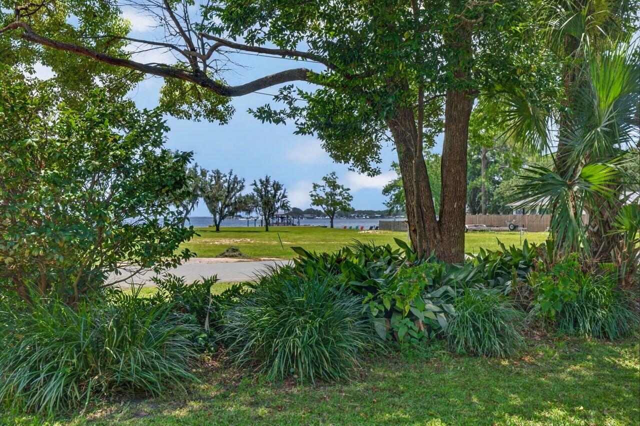 Vintage 3BR/2BA Florida cottage features incredible, panoramic waterview of Cinco Bayou, Fort Walton Yacht Club and Shalimar Point! After you've taken in the view, enjoy the highlights which include original hardwood...screened porch...lush, dense backyard with ornamental pond...one-car garage...distressed-brick drive...white/gray kitchen with tile backsplash & quartz countertops...kitchen pass-through to Dining Room & built-in shelving and cabinetry! Conveniently located in the heart of Fort Walton Beach and neighborhood includes a waterfront City Park close by with shallow boat ramp, perfect for jet skis, paddleboards or small boats! Just minutes from sugar-white, sandy beaches, restaurants, shopping, Okaloosa Island Pier, boating, paddle-boarding & more! You will love the neighborhood...perfect for walking, bicycling, swimming, picnicking and making new friends!