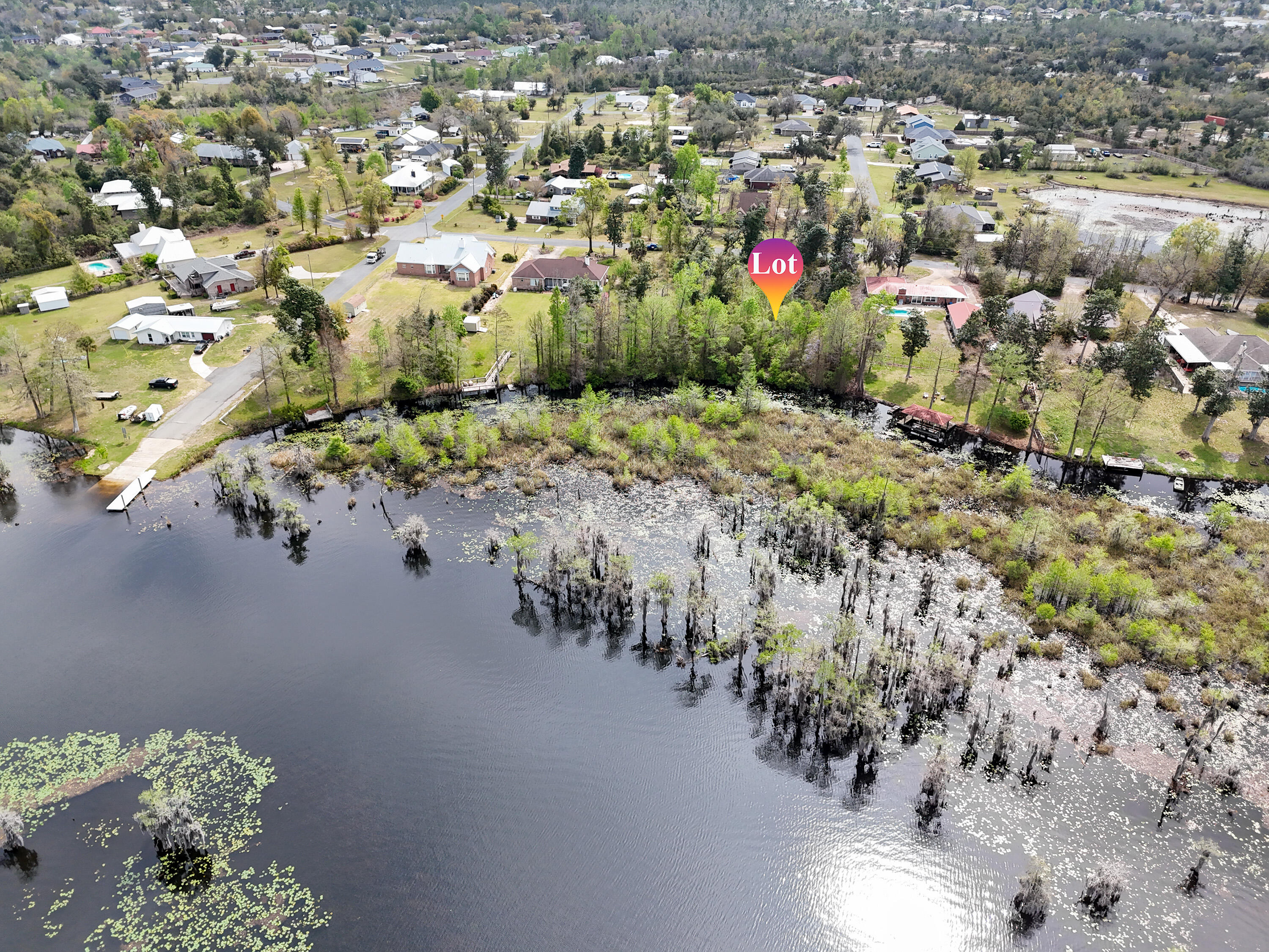 Build your dream retreat on this exceptional 0.57-acre canal-front homesite offering 100 feet of water frontage with direct access to Deer Point Lake. With serene water views & ample space to design your ideal residence, this property provides the perfect setting for a private dock, pool, workshop, or additional outdoor living features. Deer Point Lake is a 5,000-acre freshwater reservoir, formed by damming Econfina Creek, Bear Creek, and Cedar Creek, and is widely known for its outstanding fishing, boating, kayaking, and paddle boarding. Whether you envision a full-time residence or a peaceful weekend escape, this location delivers both recreation & tranquility. Conveniently situated approx 150 yards from the public boat ramp at Cedar Creek, water access is effortless. For those seeking even more space & expanded waterfront, the adjacent lot is also available, presenting a rare opportunity to own a combined 1.15 acres with 200 feet of canal frontage. This prime homesite makes an exceptional canvas for your waterfront vision with direct lake access, generous acreage, and expansion potential.