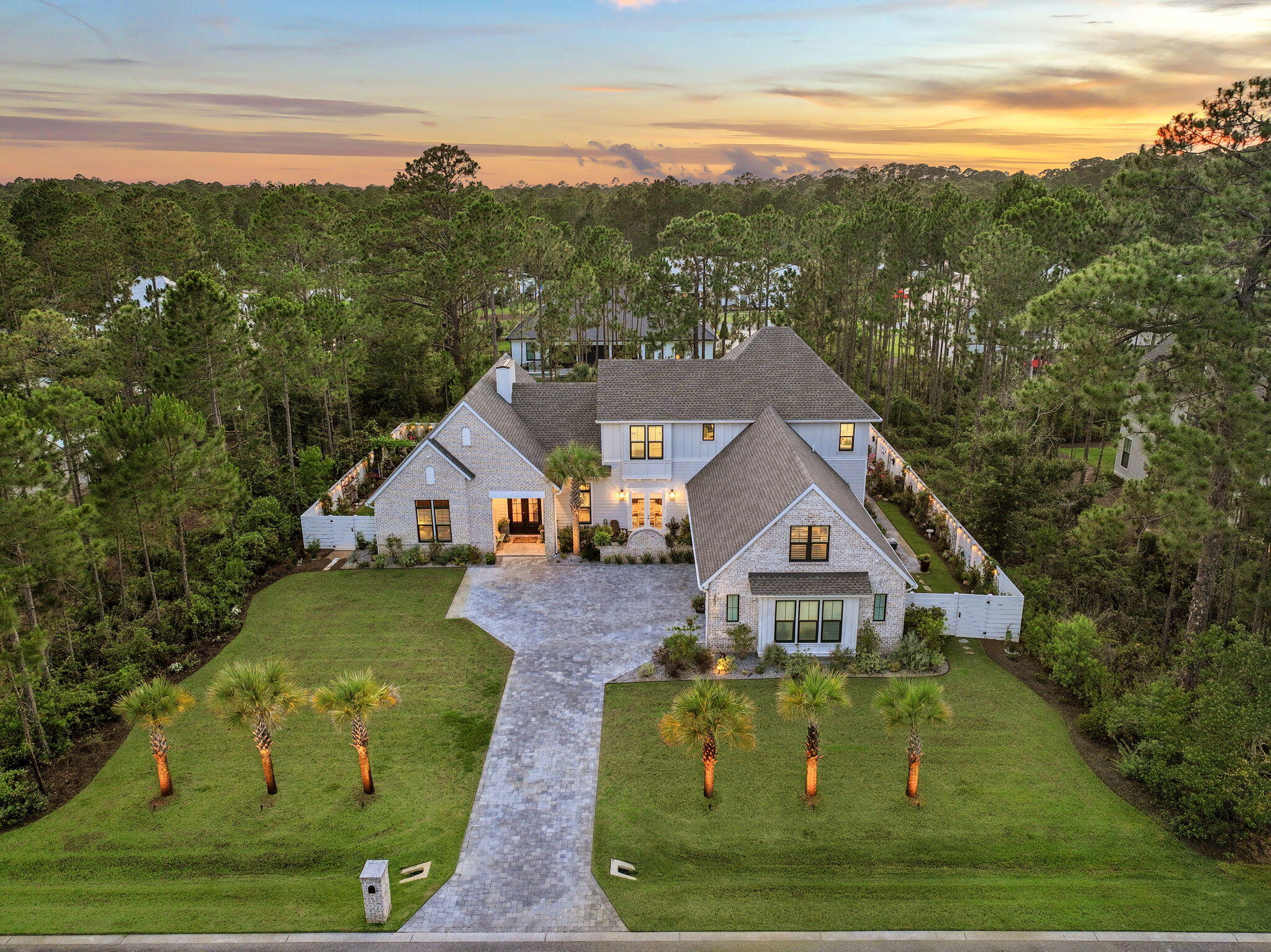 Tucked behind the gates of Seclusion Bay, this 2023 custom-built estate blends refined craftsmanship with the relaxed luxury of life along 30A. Set on a beautifully landscaped homesite framed by towering pines, this 5-bedroom, 4-bath home offers 3,866 square feet of thoughtfully designed living space, plus more than $300,000 in owner upgrades since purchase.

Inside, light oak flooring and abundant natural light set a warm, elevated tone. The chef's kitchen features crisp white shaker cabinetry, quartz countertops, a designer tile backsplash, and a professional gas range with pot filler. Spacious bedrooms and spa-inspired baths with custom leak-proof shower borders deliver comfort at every turn.

Outdoor living is exceptional. A screened, paver-deck pool with brand-new Hayward heater (2025) and app-controlled lighting (2026) anchors the resort-style backyard. A newly built fence creates multiple private outdoor spaces, surrounded by extensive custom landscaping, crushed Bahama-rock seating areas, and pre-wired pads for waterfalls and lighting. A monitored 7-camera security system and expanded garage storage round out the upgrades.

Residents enjoy gated privacy plus a private community dock, ideal for boating, paddleboarding, and sunset gatherings on the bay. Best of all, the home sits just minutes from the beaches, dining, and boutiques of Scenic 30A. Schedule your private tour today.