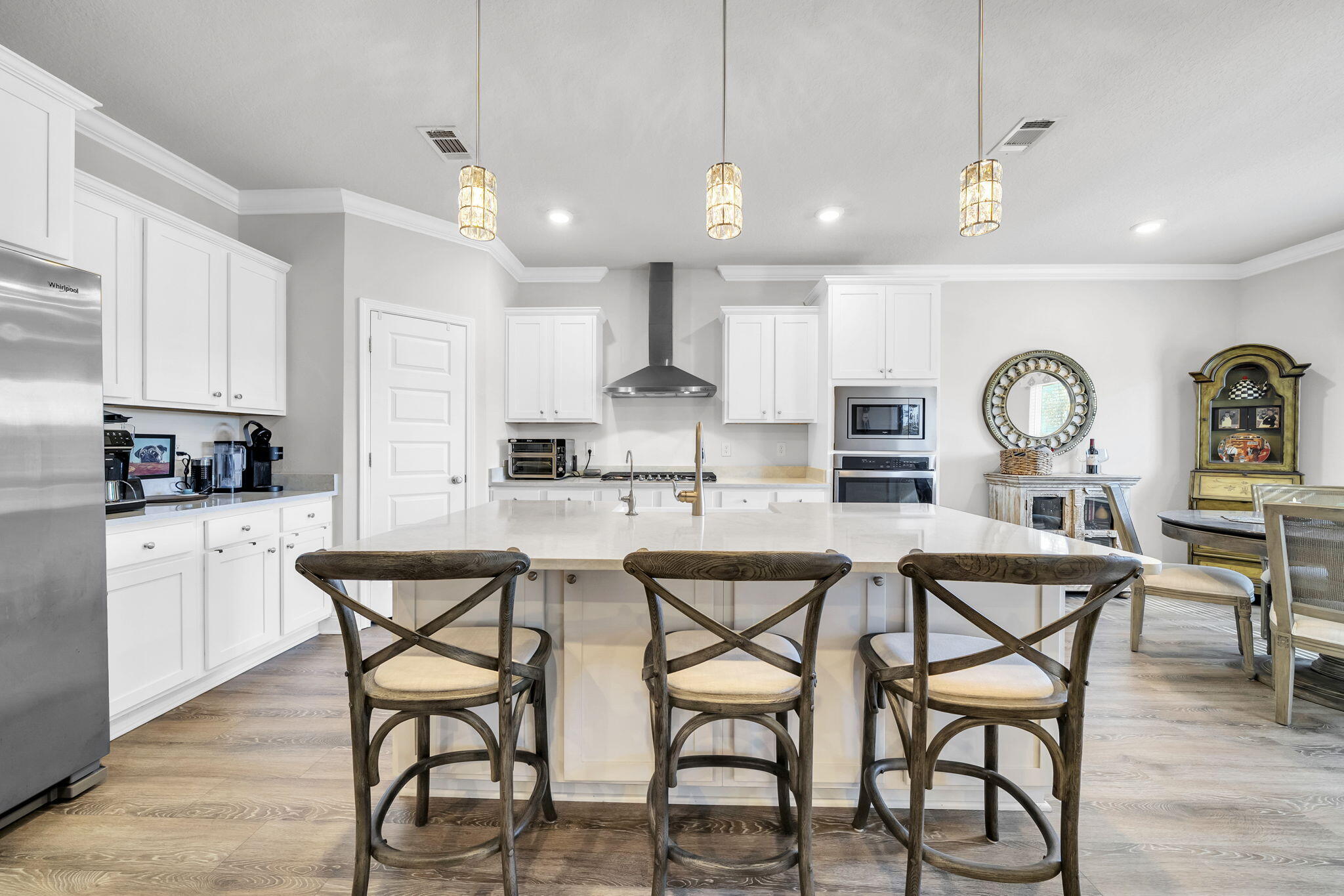 You pull into Lakeview Estates, the gate closing softly behind you, the noise of the day just . . .fades.  This is Santa Rosa Beach living the way many people hope to find it - close to everything yet comfortably tucked away.  This five-bedroom home is designed for real life.  Mornings start easily in the open kitchen, where quartz countertops, generous cabinetry, and plenty of workspace make everything from quick breakfasts to weekend gatherings feel effortless.  The kitchen flows naturally into the main living area, so conversations carry, laughter lingers, and no one feels tucked away while hosting.   The split floor plan is a quiet win.  The primary suite offers a true retreat at the end of the day, while the additional bedrooms flex to fit your life - guest rooms, home offices, hobby space, or a little of everything.  Step out to the screened porch and enjoy evenings outside without the bugs, a simple pleasure that never gets old.  The oversized garage adds breathing room for storage, beach gear, bikes, or weekend projects.  And then there's the location.  A short drive puts you at the baches, dining, and shopping along 30A, with easy access to Highway 98 when life calls you elsewhere.  Back home, the community pool and well-kept surroundings remind you why gated neighborhoods are so appealing - quiet streets, familiar faces, and a sense of ease.  With no short-term rentals allowed, Lakeview Estates is intentionally calm, making this home a great fit for a primary residence or a second home for those who want a low-traffic coastal lifestyle - close to the action, but never caught in it.