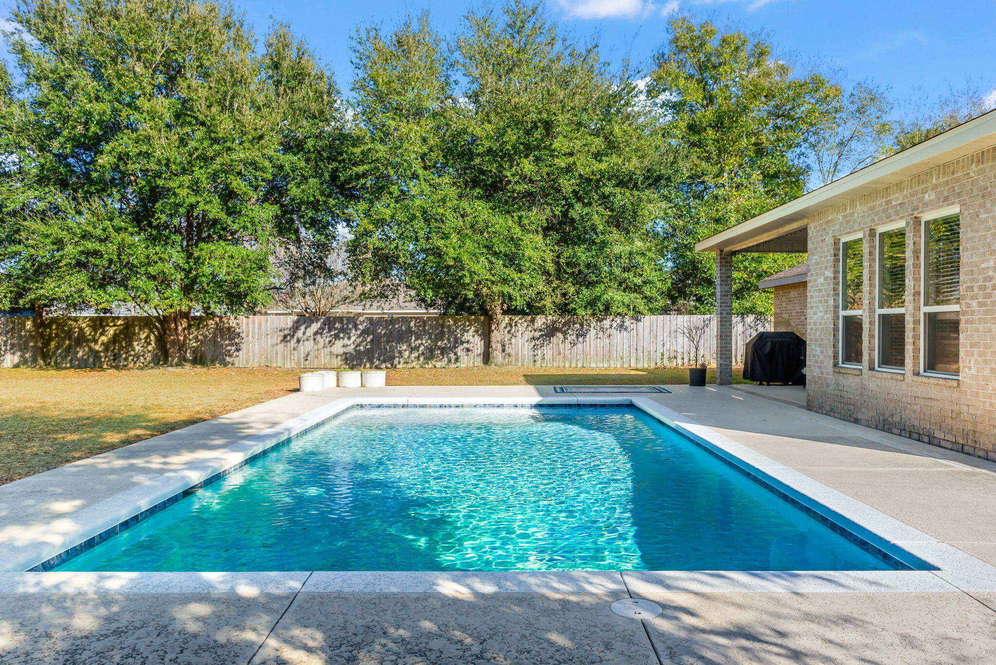 Step into this BEAUTIFUL CRAFTSMAN style home, perfectly located off Hwy 98, Hwy 87, and just a few miles from the SUGAR-WHITE sands of NAVARRE BEACH! This home is a DREAM come true for those seeking their own slice of the FLORIDA paradise with NO HOA and a SPACIOUS 1/2-ACRE lot - plenty of ROOM to fit the BOAT and RV! Your own PRIVATE OASIS awaits with a covered 18 X 10 PORCH, saltwater SPARKLING GUNITE POOL with bubbler SUNDECK, and a large open PATIO! Entertain with EASE - there is a FULL BATHROOM accessible from the patio! Inside there is a WELCOMING foyer leading to the GREAT room, w/ HIGH 10' CEILINGS THROUGHOUT! All 4 bdrms are good sized, as is the optional OFFICE/5th bdrm. This home has the SPACE that you need, with the OPEN living, SPLIT-FLOORPLAN layout that you are looking for!