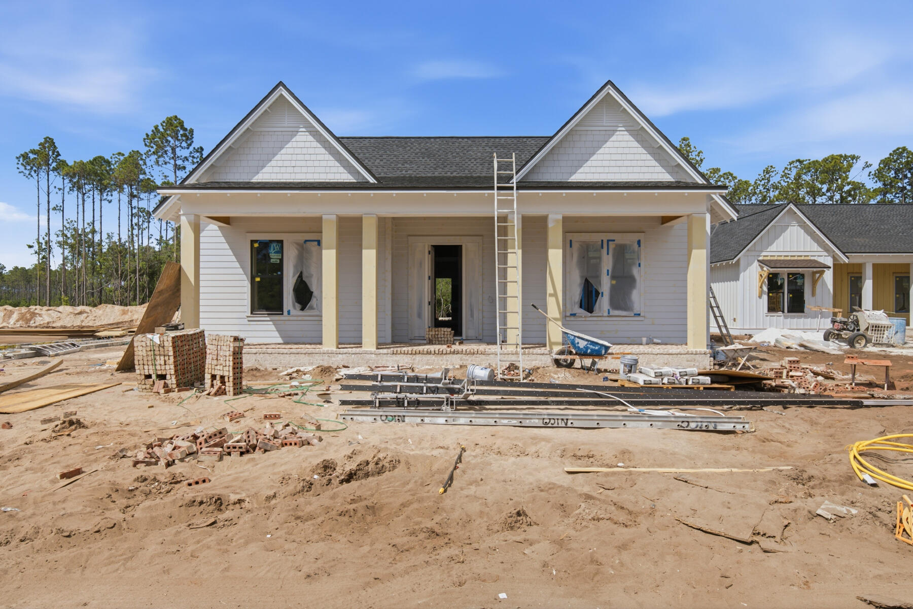 The Ficus rear-load garage plan in the Preserve Collection at Arborview Park offers 2,685 square feet, 4 bedrooms, 4.5 bathrooms, and an expanded rear-load 2-car garage connected to the home by a covered walkway. Located on a 65' x 159' homesite, the layout is designed to balance open gathering areas with separation between the primary suite and secondary bedrooms. Estimated completion is end of Sept. '26.

The foyer opens into the central living space where the kitchen, dining, and living areas connect beneath 11-foot ceilings with clear sightlines to the rear porch and pool area. A 12-foot bronze slider door extends the living space outdoors, creating a direct connection to the screened porch, saltwater pool and spa, expanded paver deck, and fenced backyard. The outdoor layout is designed to take advantage of the depth of the homesite while maintaining privacy and usable yard space.

The kitchen is positioned at the center of the home and includes a white oak island, quartz countertops, stacked glass cabinetry, custom wood hood vent, under-cabinet lighting, walk-in pantry, and an upgraded appliance package with a Wolf dual fuel range, microwave drawer, Sub-Zero refrigerator, vent hood, and Cove dishwasher. Wide-plank Medallion wood flooring continues throughout the home, complemented by crown molding, lap and gap detailing, bronze windows, and upgraded shaker-style interior doors.

The primary suite is privately positioned on one side of the home and includes a freestanding tub, walk-in shower with handheld fixture, custom closet built-ins, and a framed full-size mirror. Secondary bedrooms are arranged separately with direct bath access, supporting both guest accommodations and everyday functionality.

Additional features include painted wood shelving throughout closets and pantry spaces, laundry cabinetry with sink and countertop, generator prewire and gas line, pre-plumbing for water filtration, framed TV boxes, Decora switches, impact-rated windows and doors, tankless water heater, CAT6 wiring, and irrigation with landscaping package.