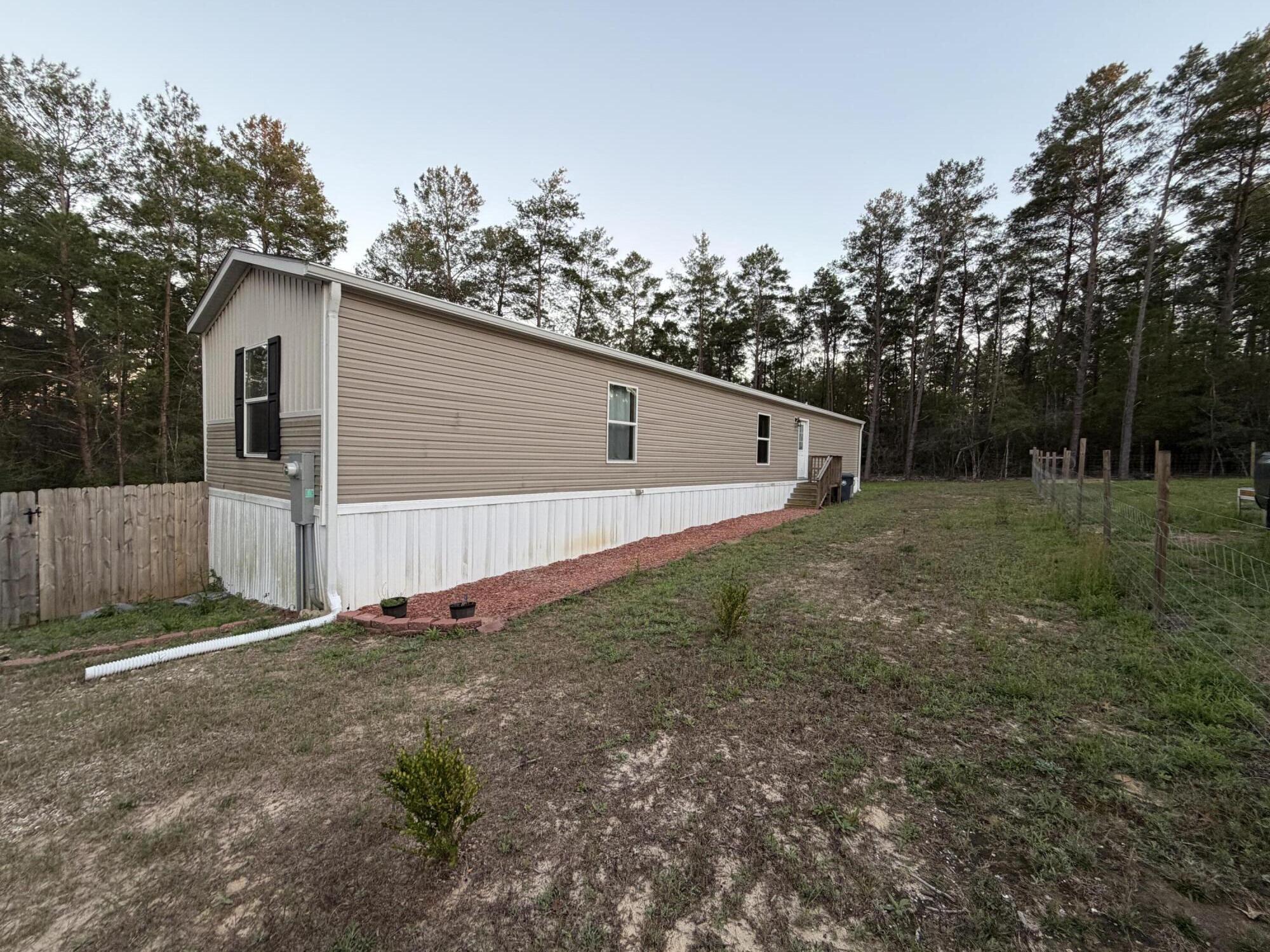** PRICE REDUCTION**

Looking for the perfect starter home? Looking for a quiet, cozy space to call home? Looking for an area where your children or grandchildren can run and play with no worries? Look no further!! 
This newer Mobile Home boasts a large primary bedroom with a walk-in closet, soaker tub in the primary bath with double vanity, an office/laundry area just off the laundry room. Open concept Kitchen and Living Room with a large island and coffee bar or bar area. Extra bedrooms are larger than your traditional mobile home rooms. Large porch area is perfect for summer cookouts and overlooks the beautiful backyard area. Privacy fence allow the kids or pups room to run and play with no worries. 
This is a home you don't want to miss!