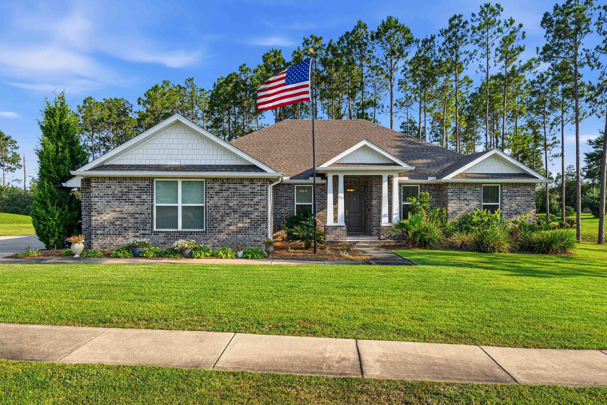 Welcome to ''Coastal Breeze Estate '' the perfect florida style living in this beautiful home located in the Gated Golf Course Community of Windswept Estates. Built by Holiday Builders in 2020 this one story brick home offers 5 Bedrooms, 3 Full Baths and sits on .84 Acres. Step into the bright and spacious layout with large windows, natural tones, generous bedrooms and living areas, perfect for gathering and entertaining. The heart of the home features an open-floor plan with modern kitchen, oversized great room, additional living area and a formal dining room.Relaxing outdoor living area with custom-built deck perfect for morning coffee, afternoon BBQs, or kids / pets play time. Plenty of room for a Private Pool & Spa, Playground or a cozy outdoor fireplace. Windswept Estates is known for its spacious homesites, beautiful amenities to include a Community pool & Pool house, Tennis and Basketball courts, Kids Playground and the well maintained 18-hole Golf Course located in the heart of the community (Separate Membership is required). Short drive to top-rated schools, local restaurants, sports complexes, and the beautiful beaches and a Bay access for fishing, boating and more.
Whether you're commuting to Santa Rosa Beach, Panama City Beach, Niceville, or Eglin AFB, you'll appreciate easy access via Highway 20. The home has a septic tank, Roof, HVAC and Water Heater are installed in 2020. Average Bills - Water $45 / Electricity $150 / Internet $200. Buyer to verify all details