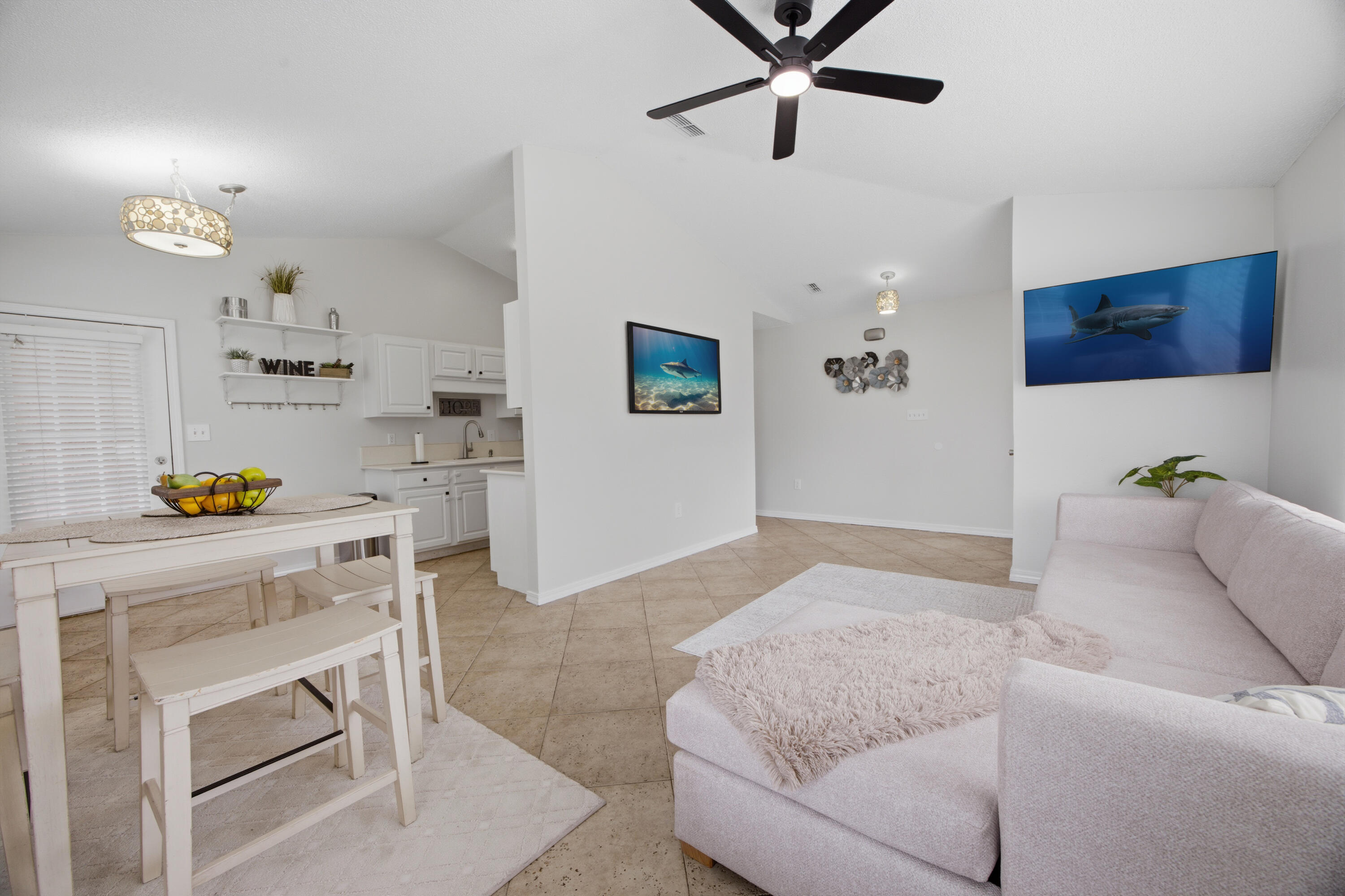 Located in the heart of Miramar Beach, Florida, 43 Mandevilla Lane offers a rare combination of coastal living, convenience, and community amenities just minutes from the sugar-white sands of the Emerald Coast. Situated less than five minutes from Geronimo Street public beach access and approximately one mile from scenic Gulf-front walking areas, this home places you close to the beach while maintaining easy access to shopping, dining, healthcare, and entertainment. This Miramar Beach home is conveniently located near Silver Sands Premium Outlets, Grand Boulevard at Sandestin, Destin Commons, Sacred Heart Hospital, and multiple local restaurants and grocery options. With direct access to Highway 98 and a traffic light positioned at the neighborhood entrance, commuting through Destin and Miramar Beach is simplified without difficult median crossings or U-turns.

Residents of this amenity-rich community enjoy access to a resort-style swimming pool, tennis courts, picnic pavilion, overflow guest parking, and community water access featuring a bayfront dock with seating. The HOA is actively improving the neighborhood with plans for a new playground and additional bayfront enhancements, adding long-term value and appeal for both homeowners and investors.

Inside, the home features high ceilings and an open-concept living area designed to maximize natural light and functionality. Interior upgrades include travertine flooring, fresh paint throughout, updated hardware, and new ceiling fans in every room. The kitchen is equipped with stainless steel appliances, while the oversized primary closet and interior washer and dryer hookup provide practical everyday convenience.

Outdoor living is enhanced with a screened-in patio featuring a finished floor, an oversized paver driveway, gutters, and partial hardscaping already in place. Major mechanical improvements provide peace of mind with a new roof installed in 2022, HVAC system replaced in 2023, and hot water heater updated in 2023.

Whether you are searching for a primary residence in Miramar Beach, a second home near the Gulf, or an investment property close to Destin's beaches, shopping, and attractions, 43 Mandevilla Lane offers location, updates, and lifestyle in one of the Emerald Coast's most desirable areas.