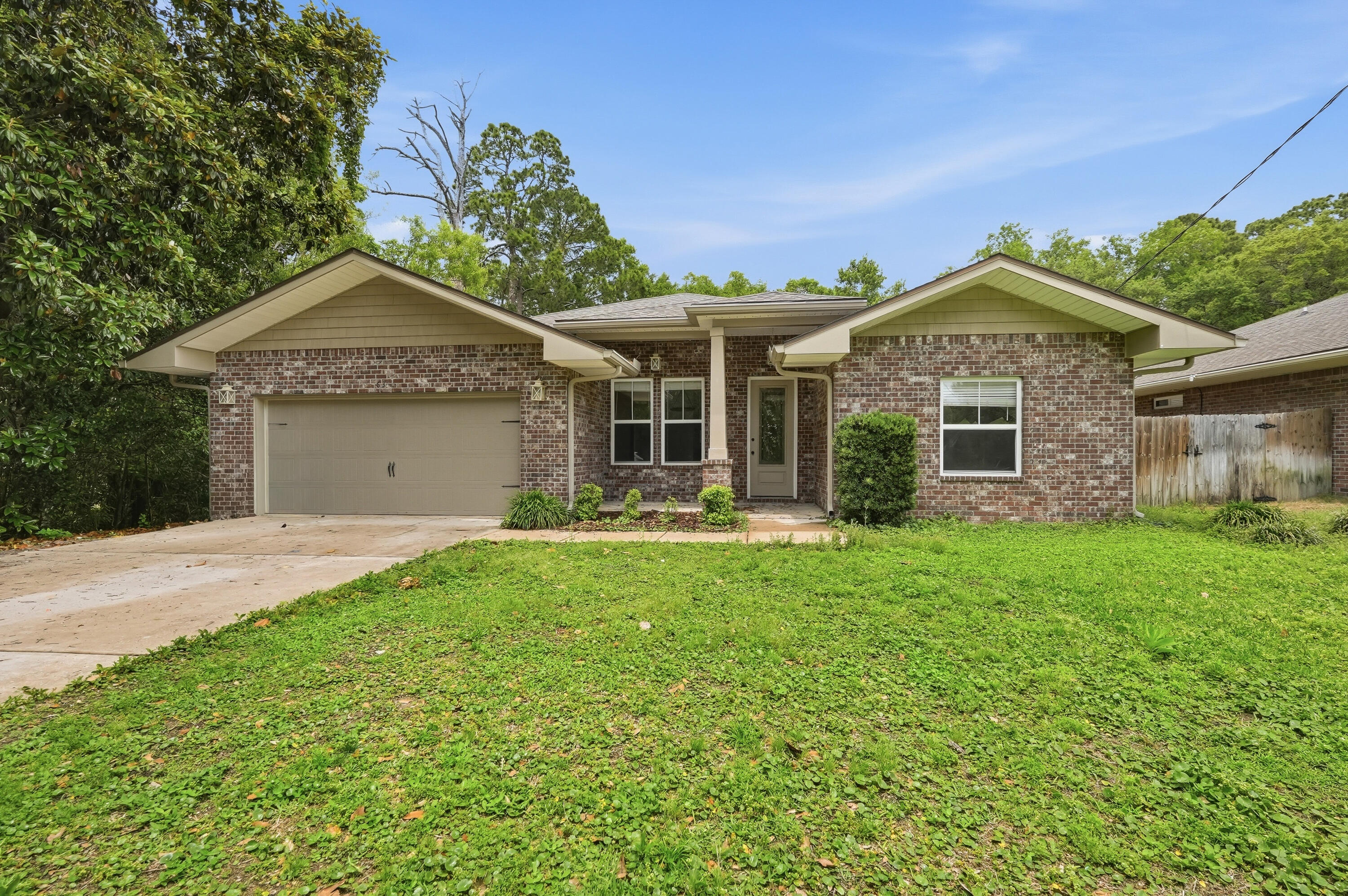 Beautifully maintained 4-bedroom, 3-bath brick home tucked away on a spacious 0.29-acre lot in the heart of Shalimar. This move-in ready home features an open-concept layout with fresh interior finishes, engineered hard wood flooring throughout the main living areas, and abundant natural light. The kitchen offers granite countertops, stainless steel appliances, wet bar with wine fridge,  custom tile backsplash, ample cabinet space, and a large breakfast bar overlooking the living and dining areas perfect for entertaining.

The spacious primary suite includes tray ceilings, dual vanities, a soaking tub, separate tiled shower, and a large walk-in closet. Additional highlights include generously sized guest bedrooms, updated lighting and fixtures, indoor laundry room, and a 2-car garage.

Enjoy a private backyard setting with mature trees while being conveniently located near Shalimar Pointe Golf Club, local parks, beaches, shopping, dining, and Fort Walton Beach. A great combination of modern updates, functional space, and desirable location!