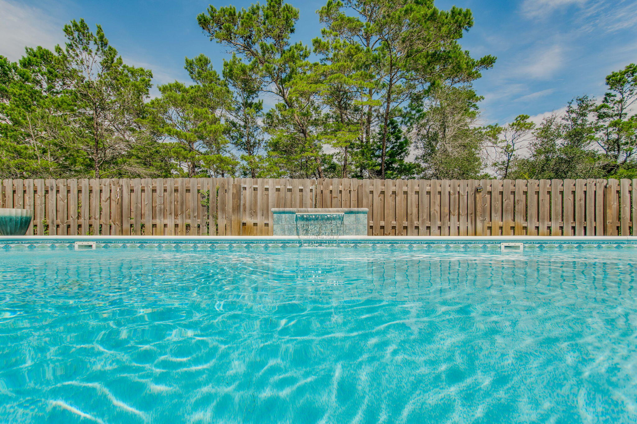 **OPEN HOUSE SAT JULY 25TH FROM 305 PM !!  LOW INTEREST RATE ASSUMABLE VA LOAN!! 

Welcome to this charming POOL home in the heart of Gulf Breeze, Florida. This delightful 4-bedroom, 3-bathroom house offers a spacious 2,304 square feet of living space, perfect for families or those who love to entertain. As you step inside, you'll be greeted by an open floor plan that seamlessly blends comfort with style. The luxury vinyl plank flooring and shiplap walls add a touch of coastal flair, while the enclosed office with a sliding barn door and closet provides a quiet space for work or study. The kitchen is a culinary enthusiast's dream, boasting granite countertops, crisp white cabinets, and gleaming stainless steel appliances. Whether you're whipping up a quick breakfast in the cozy nook or preparing a gourmet meal at the island, this kitchen has you covered.
The primary bedroom is a true retreat, featuring an ensuite bath with a double vanity, walk-in closet with custom shelving, stand-up shower, and a garden tub that's practically begging for a bubble bath and a glass of wine. 
Outside, the inground saltwater pool is perfect for those hot Florida days. The fenced-in yard provides privacy and peace of mind, while the exterior Hardie board siding offers durability and low maintenance. And for all you car enthusiasts (or just those with a lot of stuff), there's a spacious 3-car garage. There is also a sprinkler system and well to make yard maintenance a breeze!!

Located just a short distance from local attractions, you'll find the Lighthouse Private Christian Academy, Soundside Public Beach, and the Gulf Breeze Zoo nearby. Imagine spending your weekends alternating between beach days and animal adventures!
This home isn't just about looks - it's practical too. With a termite bond in place, you can rest easy knowing your investment is protected. And let's not forget the charming front porch - the perfect spot for sipping sweet tea and waving to neighbors.