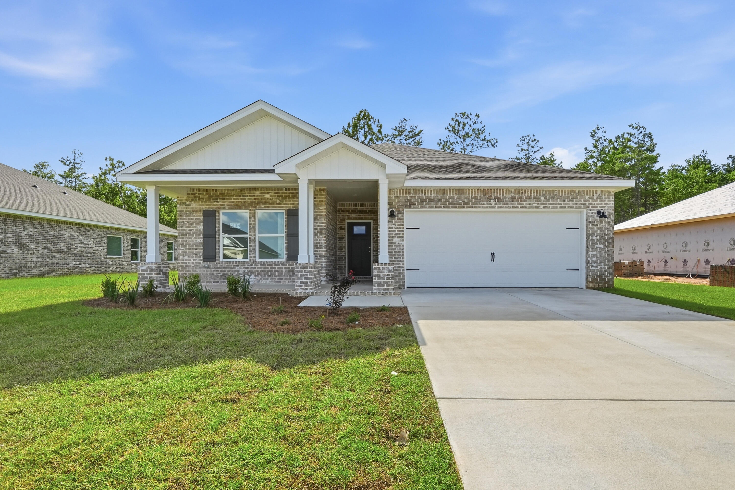 READY NOW -  'MAYBELL' STRETCHED OUT TO 1616 SF - $15,000 towards closing costs/prepaids/rate buydown. 'Southern Charm S/D' has low county taxes, no HOA.  Seamless flow from the foyer to open family gathering space overlooking kitchen/dining nook.  Raised ceilings, recessed lighting with luxury vinyl plank flooring in main areas.  Quartz work island has bar seating, white shaker style cabinets + corner pantry.  Split BR plan with owner's bath featuring double vanities, walk-in closet, shower only & linen storage.  Cozy front and rear porches, landscaped 1/4-acre lot, and finished garage. INTERIOR PHOTOS OF SIMILAR SOLD HOME COLORS & FINISHES WILL VARY.