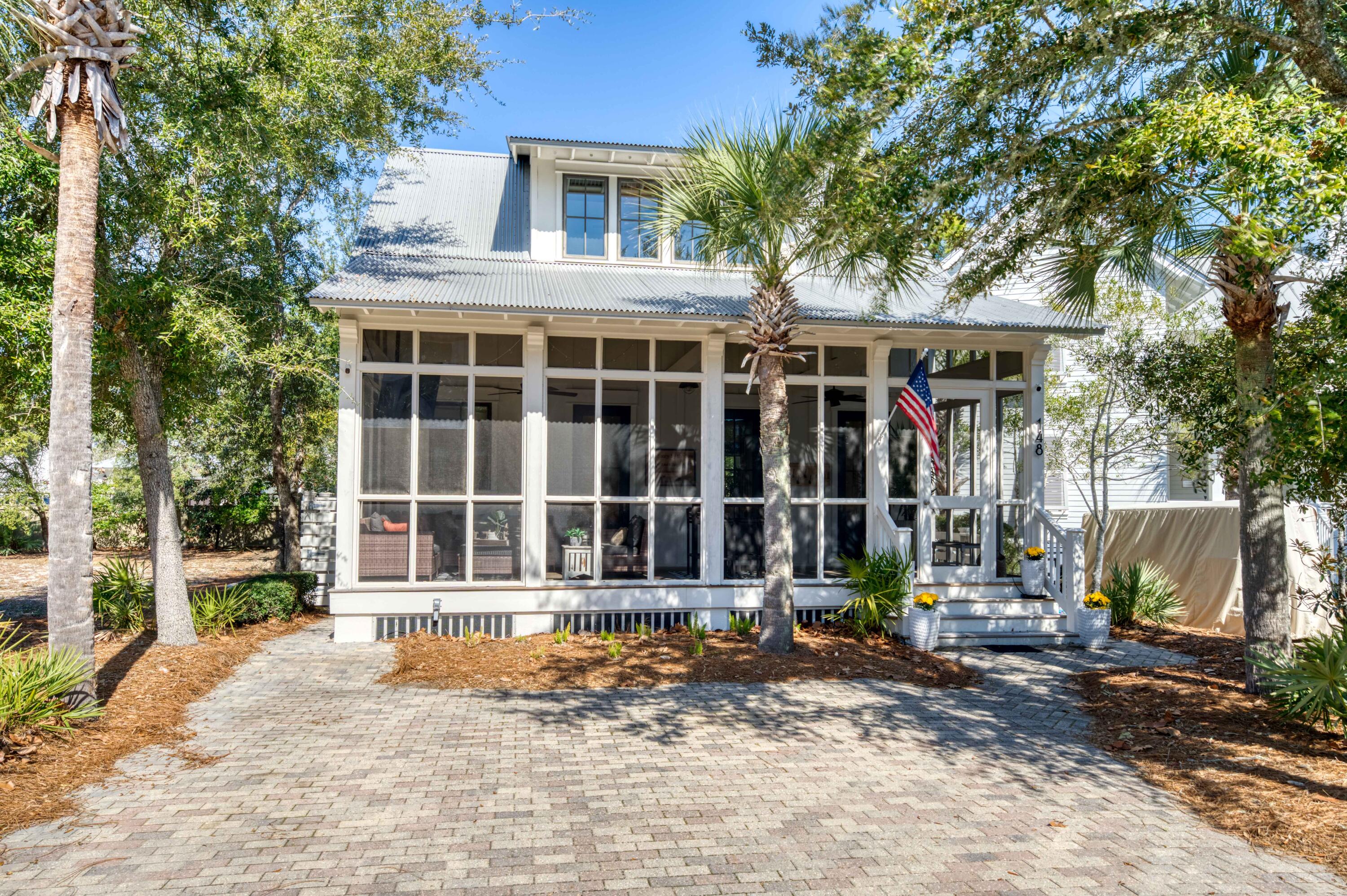 Located in the highly sought-after gated community of Cypress Dunes along Scenic Hwy 30A, 148 Cypress Walk presents an outstanding opportunity for investors, second-home buyers, or those seeking strong short-term rental potential in Santa Rosa Beach, Florida. This beautifully designed 3-bedroom, 3.5-bath coastal residence offers 1,957 square feet of thoughtfully designed living space with a highly desirable open-concept floor plan ideal for entertaining and guest accommodations.

A full-width screened front porch creates inviting outdoor living space with peaceful views of the quiet tree-lined street--perfect for relaxing after a day at the beach or hosting guests year-round. Inside, the bright and airy living and dining areas feature abundant natural light, hardwood flooring, and a classic white fireplace with gas fire, delivering timeless coastal charm.

The well-appointed kitchen is designed for both everyday functionality and vacation living, featuring granite countertops, stainless steel appliances, and a spacious center island that seamlessly connects the main living areas. With its prime 30A location, strong rental appeal, and access to the exceptional amenities of Cypress Dunes, this seller-motivated property offers incredible value and investment potential along the Emerald Coast. Designed for effortless coastal living, the first-floor primary suite offers privacy and convenience with direct porch access, allowing seamless indoor-outdoor living on the main level without constantly navigating stairs. Upstairs you'll find two additional bedrooms, each with its own bath, along with a versatile loft space perfect for a home office, reading nook, or additional sleeping area. The home's light-filled design creates a relaxed coastal feel throughout, making it a welcoming retreat for both owners and guests.

Located within the gated Cypress Dunes community on 30A, residents enjoy resort-style amenities including a stunning Gulf-view infinity pool with spa, a two-level clubhouse, fitness center, tennis courts, and a scenic boardwalk bridge crossing the community's namesake cypress lake. The neighborhood is known for its friendly atmosphere, with regular gatherings and events at the amenity center that bring neighbors together.

This property also presents a lucrative short-term vacation rental opportunity, benefiting from strong guest demand within the Cypress Dunes community and its prime location along Scenic Highway 30A. Ideally positioned in Santa Rosa Beach, the home offers convenient access to some of the area's most popular restaurants, Gulf beaches, and outdoor recreation while remaining tucked away from heavy traffic. Residents and guests enjoy daily walks to the beach, exploring the nearby cypress forest trails, and easy access to Topsail Hill Preserve State Park, making this an ideal coastal retreat for both personal enjoyment and investment potential.

What owners love most is how effortlessly the home captures the relaxed 30A coastal lifestyle--whether enjoying morning coffee on the porch, afternoons at the beach, or evenings watching the sunset with friends and family. With its prime location, strong rental performance, and welcoming community setting, 148 Cypress Walk offers an exceptional opportunity for a primary residence, second home, or high-performing investment property in Santa Rosa Beach.

Recent Improvements & Upgrades by Owner Include:
Extensive updates and enhancements have been completed since ownership, including a completely rebuilt fireplace with brick masonry, new flue, chimney cap, and gas log set with wall switch start. The home also features an on-demand gas water heater, updated kitchen appliances including refrigerator, stove, microwave, oven, and additional beverage refrigerator, along with a newer washer and dryer (approximately one year old). The primary suite has been enhanced with updated shower plumbing and a custom-built primary closet system.

Additional improvements include a newly added office space off the kitchen, custom shelving and pantry upgrades with tiled flooring, new window coverings in the office, and updated LED lighting throughout the home. Outdoor upgrades include irrigation for flower pots, screened enclosure beneath the home to prevent critters, an outdoor shower with enclosure, storage shed, and dedicated trash enclosure. The driveway has been extended with additional parking and sidewalks added along both sides of the home. Additional exterior enhancements include new wood steps at the front and side entrances, added porch lighting and ceiling fans, a TV on the screened porch, and exterior paint completed in 2024 with interior paint completed in 2022. There are newly added security cameras, remote locks and remote lighting. The home is also being offered furnished with all new updated TVs, bedding, and household items, making it move-in or rental ready.