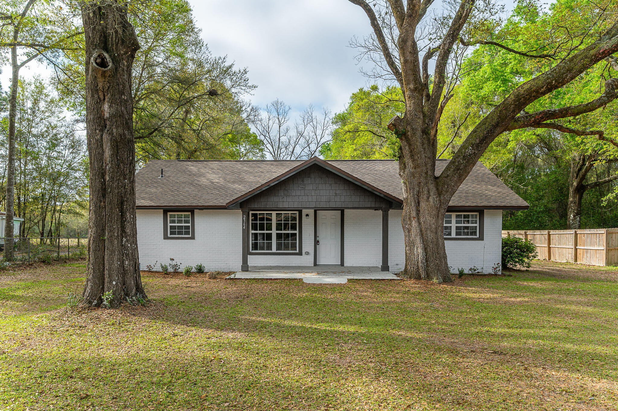 SELLER IS OFFERING BUYER'S CLOSING COST ASSISTANCE! This extensively renovated home offers just over 1,600 square feet of living space and sits on nearly half an acre, providing both space and value. Recent upgrades include a new roof with transferable warranty, newly installed windows, updated cabinets, luxury vinyl plank flooring throughout, and beautiful granite countertops. The breakfast bar adds convenience for everyday living, while the separate dining room is ideal for family meals and entertaining. The office or fourth bedroom features a cozy fireplace and an expansive glass door, filling the space with natural light. Outside, the front yard features newly installed sod and is shaded by stunning mature oak trees. Don't miss this opportunity--call today!