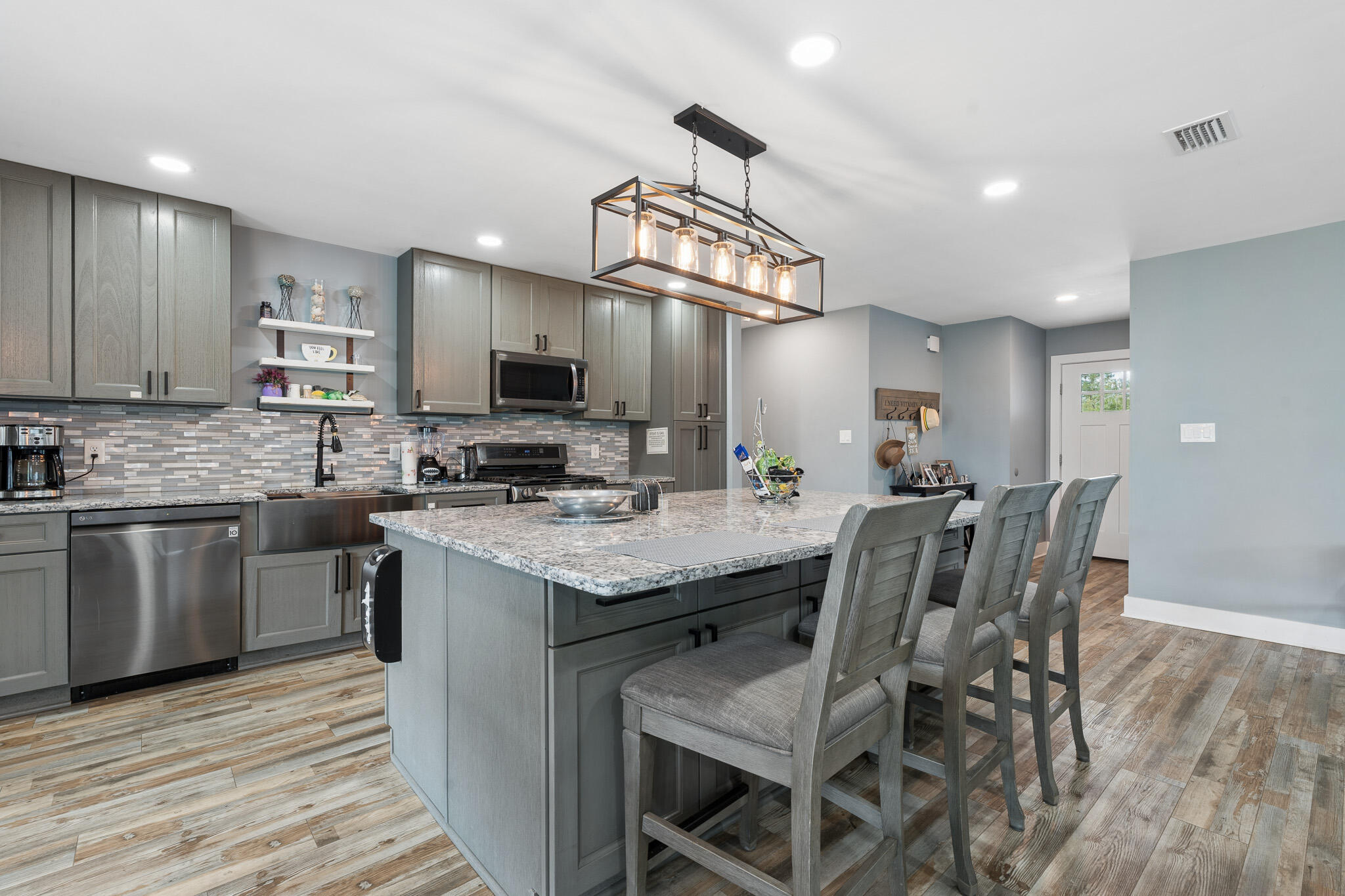 $5K toward Buyers closing costs!  This beautifully updated like-new home in Callaway offers modern comfort, thoughtful upgrades, and convenient access to everything the area has to offer. Located just minutes from shopping, restaurants, and waterfront recreation, enjoy being approximately 0.4 miles from fishing charters at Pier 98, 1.4 miles to a public boat ramp, 4 miles to Tyndall Air Force Base, and about 33 miles to St. Andrews State Park. Extensively remodeled and brought down to the studs following the hurricane, this home features updated electrical, plumbing, and gas lines for added peace of mind. Designed with efficiency and comfort in mind, upgrades include a tankless gas water heater, whole-house generator, solar panels that will be paid off at closing, impact-resistant windows, and automatic shades. The kitchen is a standout with stainless steel appliances, gas range, quartz countertops, decorative glass backsplash, and an oversized island with ample space for entertaining, gathering, or game nights. Interior finishes include recessed lighting, updated fixtures, and luxury vinyl plank flooring throughout. The spacious primary suite features dual closets and a spa-inspired bath complete with an open walk-in shower, jetted soaking tub, Bluetooth speaker, and smart lighting features. The guest bath has also been tastefully updated with a glass tub enclosure, quartz countertop, and decorative sink. Exterior improvements include durable Hardie board siding and a  standing seam metal roof with all roof boots resealed in 2025.  Step outside to enjoy the covered patio and fully privacy-fenced backyard. A 12x20 site-built shed with insulation, electricity, and its own covered patio provides excellent flexibility for hobbies, storage, or workspace. The backyard is enhanced with fruit trees, a fire pit area, and an additional exterior outlet ready for future outdoor additions such as a hot tub. Don't miss your opportunity to own this extensively upgraded home with modern conveniences and room to enjoy both indoors and out. Buyer to independently verify all information, measurements, dimensions, restrictions, and any matters deemed important.
