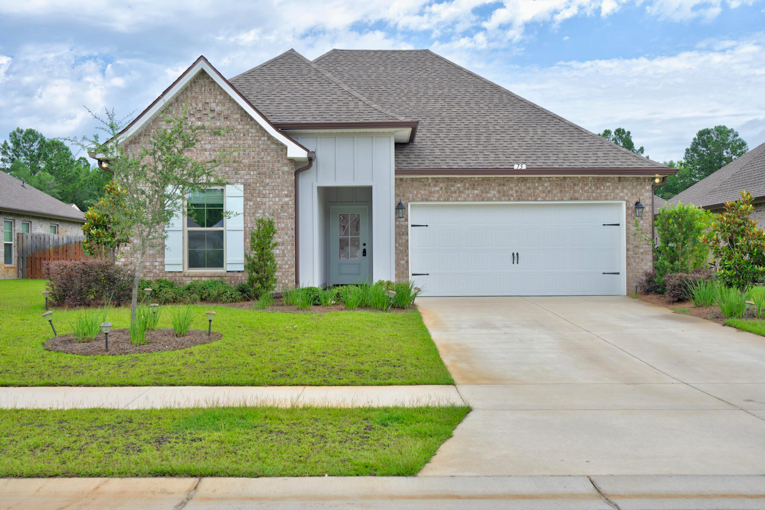 $5,000 FLEX CASH with full-price offer! Welcome to 75 Apollo Avenue E, located in the desirable Moonswept at Hammock Bay community in Freeport. This beautifully designed Trillium IV G floor plan offers 3 bedrooms, 2 bathrooms, and a thoughtfully crafted open-concept layout that combines comfort, functionality, and modern style.

Inside, you'll find an inviting living space accented by crown molding, recessed lighting, and abundant natural light. The kitchen serves as the heart of the home, featuring a large center island, walk-in pantry, undermount sinks, framed mirrors, and plenty of storage and workspace for everyday living and entertaining.

The spacious primary suite provides a relaxing retreat with a double vanity, garden tub, separate custom-tiled shower with frameless glass door, and a generous walk-in closet that conveniently connects directly to the laundry room. Two additional bedrooms offer flexibility for guests, a home office, hobbies, or other lifestyle needs.

Enjoy Florida living year-round from the covered front and rear porches, while the professionally designed landscaping package enhances the home's curb appeal. Additional features include smart-home technology with a Wi-Fi-enabled thermostat, smoke and carbon monoxide detectors, architectural 30-year shingles, flood lights, and numerous builder upgrades throughout. Designed with efficiency in mind, this home also includes energy-conscious features such as Low-E vinyl windows, an energy-efficient water heater, and a kitchen appliance package with an electric range.

Situated within the amenity-rich Hammock Bay community, residents enjoy access to a variety of recreational amenities, walking paths, green spaces, and community gathering areas. Conveniently located near shopping, dining, outdoor recreation, Choctawhatchee Bay, and the beautiful beaches of South Walton, this location offers easy access to everything the Emerald Coast has to offer.

Don't miss the opportunity to make this exceptional home your own. Schedule your private showing today!