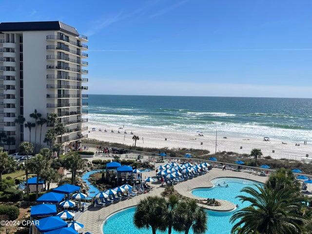 GULF-FRONT BEDROOM | PENTHOUSE | ROOFTOP DECK | A stylish two-story condo for sale in Panama City Beach, Florida. You've found a turn-key residence at exclusive Edgewater Beach & Golf Resort that offers a sense of ease. It is fully furnished and ready as a short-term rental investment or your own personal oasis. The first-floor pops with coastal colors, quality furnishings, and a private beach view balcony. The popular Gulf-front owners suite features floor-to-ceiling windows, bathroom with separate tile shower, and balcony access. There is attractive, easy-care tile and vinyl plank flooring throughout. A spiral staircase leads to a second level loft space that elevates this seaside experience. The space looks out to a fresh air open deck with panoramic water scenes and soul touching sunsets. The loft offers a sleeping area, wet bar, and bathroom. There is a lot of new in this recent remodel, from furniture to lighting to appliances, and the big-ticket items have already been replaced: AC 2014; water heater 2024; washer/dryer 2023. Edgewater is a securely gated resort with convenient building-side parking, electric vehicle charging stations, and a lot for boats and trailers. Included in the HOA dues are exclusive amenities such as beach access, the infamous Lagoon Pool, Hot Tubs, and Rental Cabanas. There is a Kids Club with splash pad and planned activities. All of the beachfront towers feature a tropical heated Pool, Hot Tub, and Sun Deck. Oceans Restaurant & Bar serves delicious food year-round and hosts special events. There is also a handy market serving ice cream and Starbucks. Owners enjoy a Sports Club Membership: Golf, Pickleball, Tennis, Basketball, Shuffleboard, and Fitness Center. There is an onsite Tram to bring you over to the sports club amenities, or it's just a short walk. The property is walkable to dining, shopping, and entertainment right across the street. It is centrally located so you can drive, uber, or take the trolley to exciting Pier Park in just a few minutes. Resort owners can bring their pets. Ask for a Cost To Own Estimate and let us help you discover a path to the coastal lifestyle of your dreams!