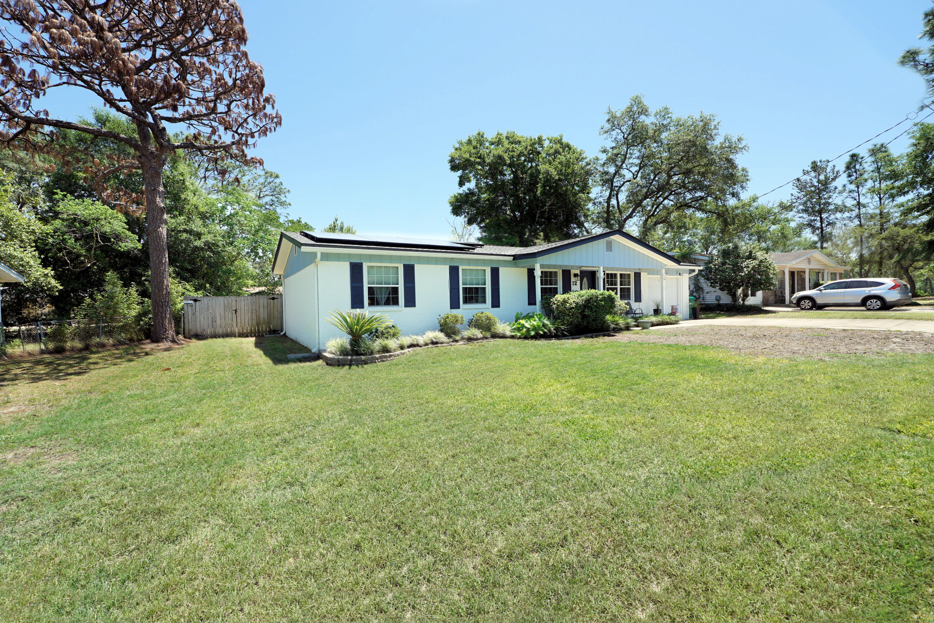 Here is your opportunity to own a home in highly desirable Shalimar, Florida! Only minutes from Eglin AFB and the most beautiful beaches along the Gulf Coast, this home is going to offer you the coastal lifestyle you're looking for! A classic Florida-style cottage, this home has four bedrooms and two full, recently renovated baths. The family room opens to the dining area and kitchen, making for an ideal entertaining space. The current owners use one of the bedrooms as a music room, as it is adjacent to the family room and is connected by french doors. Down the hall are the two other guest rooms, as well as a full bath. The primary bedroom is at the rear of the home, with an attached bath. Off of the dining area is a screened porch, which will see a lot of use! (Click More . . .) Then, you'll make your way out to the separate 12x12 screened room, which is home to a large hot tub! The backyard has privacy fencing--so grab your beverage of choice and dash out to enjoy a relaxing soak! Roof, Water Heater and HVAC have all been replaced within the last 5 years. Solar panels (paid off in May!) were added after the roof was replaced--so your electric bill is typically just the basic connection fee (approximately $30/month, with a bump in Jan & Feb to approximately $60). New sod in the front yard is thriving! Come see this gem!