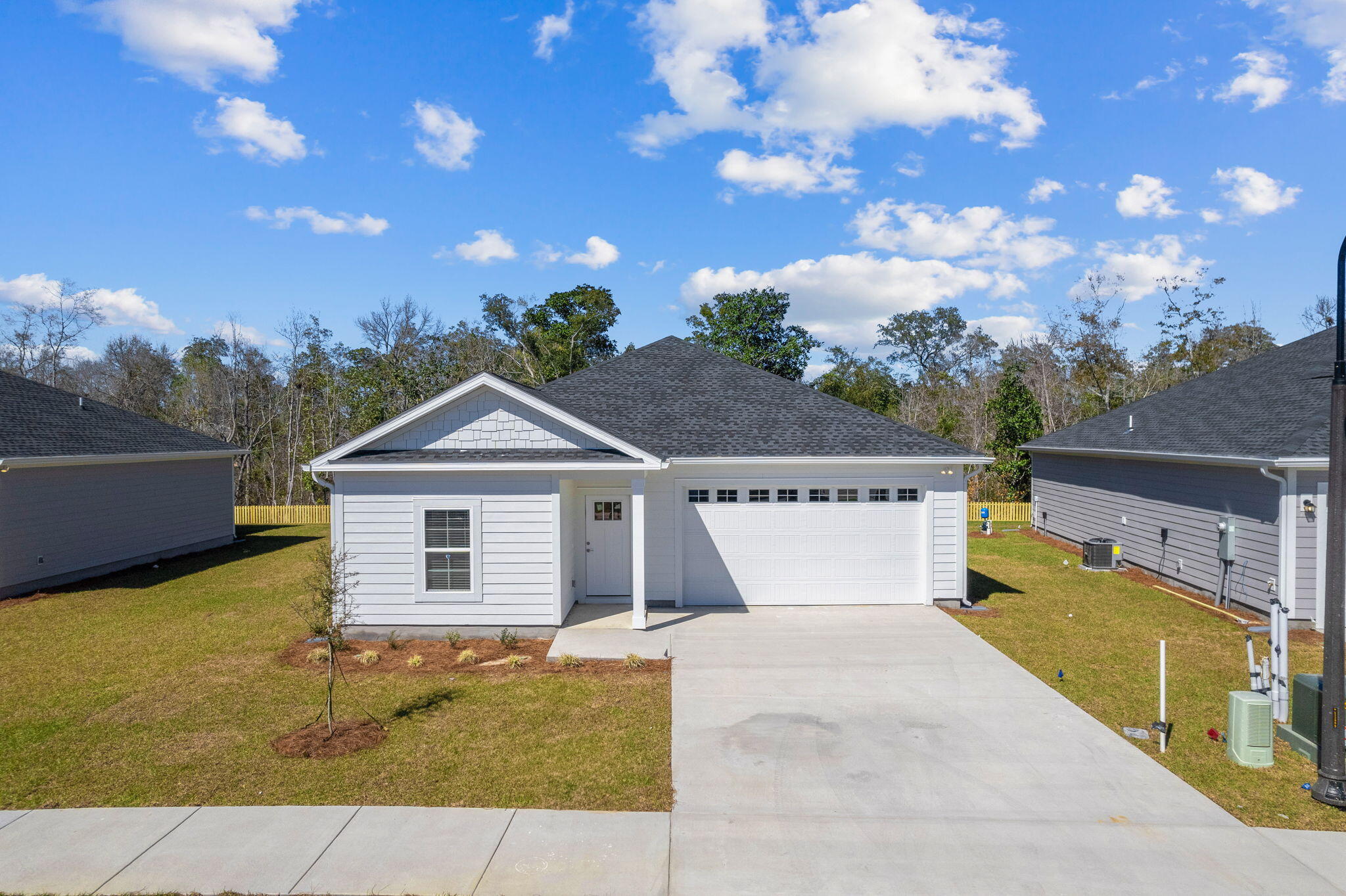 $5,000 closing cost credit with preferred lender & title + fridge and blinds INCLUDED! A stunning new construction home in the highly desirable Riverwalk community. Construction is COMPLETE on this custom coastal-inspired residence offers a spacious two-car garage, 1850 square feet of living space, and an open floor plan for seamless living. The kitchen features quartz countertops, white shaker cabinets, luxury vinyl plank flooring, and stainless steel appliances. With superior workmanship and an upgraded trim package, this home exudes quality and style. The exterior features fiber cement HardiePlank siding, a covered patio, and the option for a screened porch and fenced-in backyard.