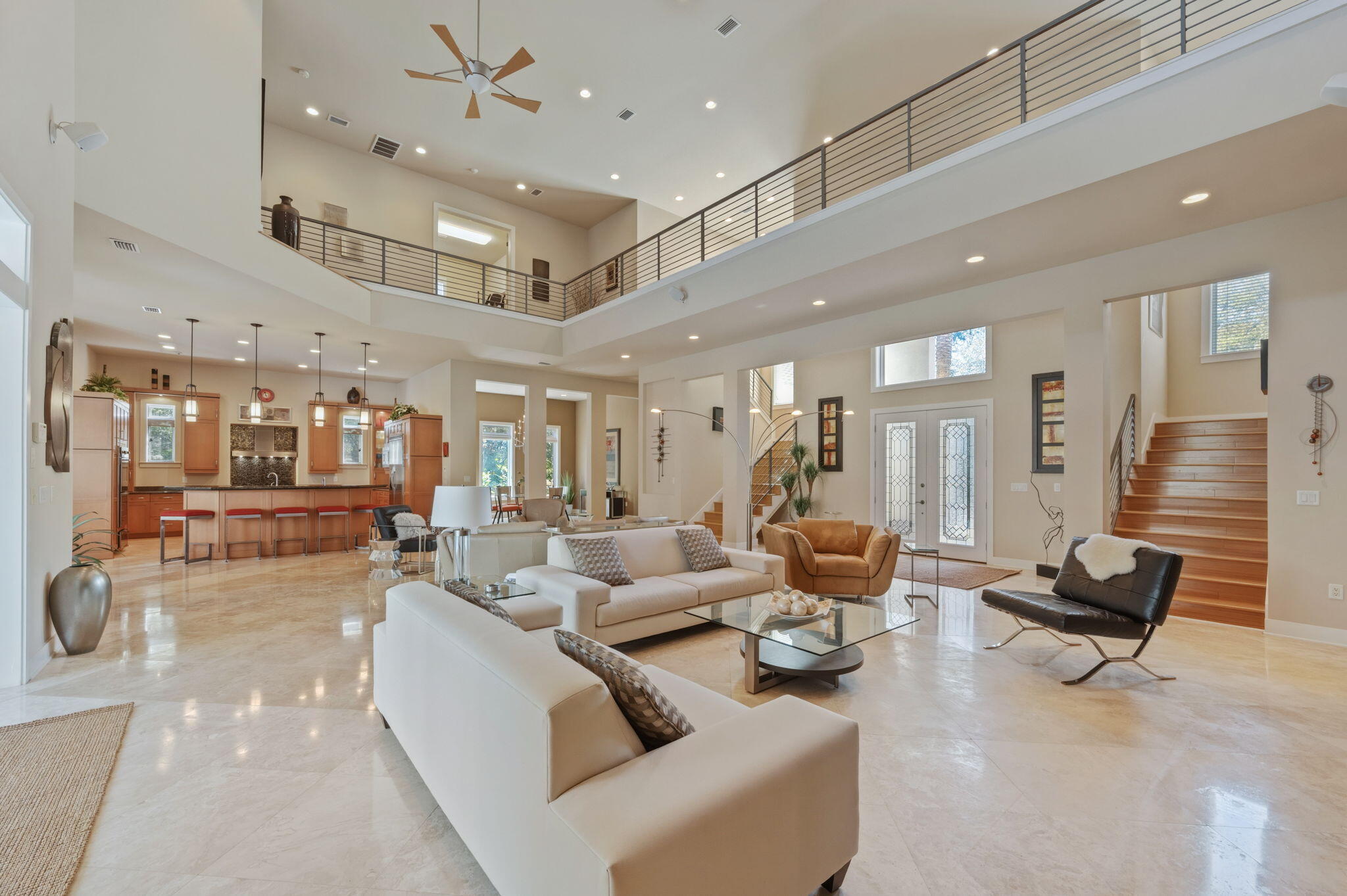 Experience refined coastal luxury in this exceptional 4-bedroom, 4-bath estate located within the prestigious Burnt Pine enclave of Sandestin Golf and Beach Resort. Offering 6,079 square feet of thoughtfully designed living space (9,272 sq ft under roof), this residence showcases sweeping lake and golf course views, soaring ceilings, and an abundance of natural light throughout. The grand living area features a gas fireplace, custom built-ins, and expansive windows that seamlessly connect indoor and outdoor living. The chef's kitchen is designed for both entertaining and everyday living, complete with premium Viking appliances, an oversized island, breakfast bar, and sleek modern finishes.  Step outside to a private resort-style outdoor retreat featuring a covered pool, hot tub, summer kitchen, and outdoor fireplace--ideal for year-round enjoyment.
The first-floor primary suite offers direct pool access and a spa-inspired bath with sauna. Additional main-level features include a private office (optional bedroom), wet bar with ice maker, beverage refrigerator, wine cooler, and a laundry room with dog wash station.
Upstairs, a dramatic catwalk overlooks the main living spaces and leads to multiple guest accommodations, including flexible living areas, a fitness room, and covered balconies with scenic views. Additional highlights include: Three-car garage plus dedicated golf cart garage, Offered fully furnished (with exclusions) Whole-home Cummins generator.  2943 Pine Valley is located in the beautiful Sandestin Golf and Beach Resort which spans over 2,400 acres from the Gulf of Mexico to the Choctawhatchee Bay and offers world-class amenities including: Over 7 miles of beaches and bayfront, Four championship golf courses, 15 tennis courts and fitness center
226-slip marina and full-service spa, Dining, shopping, and entertainment at The Village of Baytowne Wharf, Miles of golf cart, biking, and walking paths throughout the resort. This property presents a rare opportunity to own a luxury home in one of Northwest Florida's most sought-after resort communities--ideal as a primary residence, second home, or investment property.