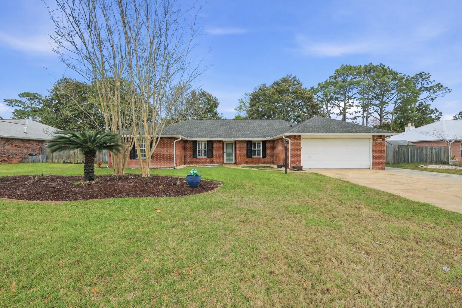 Beautifully maintained split-bedroom home in desirable Raintree Estates in Bluewater Bay! The spacious primary suite is privately located on one side of the home, with three additional bedrooms on the opposite side. Inside you'll find hardwood floors, a formal dining room, a dedicated office, and a welcoming living room with a wood-burning fireplace. The kitchen features granite countertops, stainless steel appliances, and an island/bar perfect for prep or casual dining. The primary ensuite offers two closets, garden tub, a separate shower, and a double vanity. Enjoy the large privacy-fenced backyard, great for relaxing or entertaining. Voluntary HOA ($150/year) provides access to the beach park with water walkover, walking trails, dock, and ball field: roofa  2020, HWH 2022.