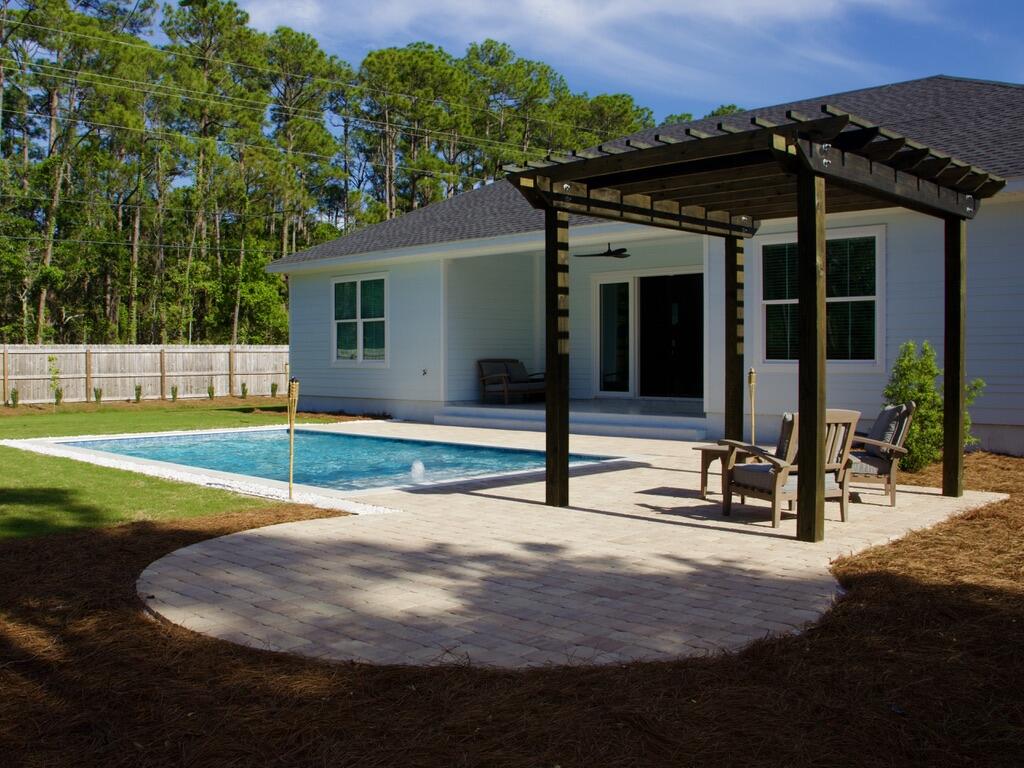 Completed in 2024 and ideally located just north of Hwy 98 with easy access to 30A West, this 4BR/2BA home sits on a spacious ~0.31-acre lot with no rental restrictions. The newly finished backyard offers a private retreat with a pool, paver deck, pergola, and thoughtful landscaping. Inside, the home features 10-foot ceilings, tile flooring, crown molding, and custom trim throughout. A wide three-panel sliding door fills the living area with natural light and opens to the backyard. The primary suite includes a soaking tub, a walk-in shower with a rain head, and a custom closet. Fully fenced with irrigation and a paver driveway. Located ~1.2 miles to Bay Circle Boat Ramp and ~3.5 miles to beach access. Sunlight, space, and coastal charm come together in this beautifully built 2024 home just north of Hwy 98, with easy access to 30A West. Set on a generous ~0.31-acre lot, this property offers the rare combination of privacy, flexibility, and room to breathe, all just minutes from the Emerald Coast's beaches, dining, and boating.
The newly completed private pool and outdoor living area create a backyard designed for relaxing afternoons and effortless entertaining. Surrounded by a spacious paver deck and thoughtful landscaping, the outdoor space feels like your own personal retreat. 
Inside, the home feels bright, open, and welcoming. Ten-foot ceilings, elegant trim details, and large impact windows fill the space with natural light while adding a polished coastal feel. The open living area is anchored by a striking tile-wrapped fireplace, creating a warm focal point for gathering with family and friends.
The kitchen is truly the heart of the home, featuring an oversized quartz island perfect for morning coffee, casual meals, or hosting. It flows seamlessly into both a breakfast area and an additional flexible dining space that can easily adapt to your lifestyle -- whether you envision a second lounge, play area, or entertaining space.
A wide three-panel sliding glass door connects the indoors to the backyard, creating that seamless indoor-outdoor living experience that makes coastal homes so special.
The primary suite offers a peaceful retreat, complete with a freestanding soaking tub, spacious walk-in shower with rain head, and a custom walk-in closet. Thoughtful storage and built-in organization throughout the home add convenience without sacrificing style.
The yard is fully fenced and provides both privacy and curb appeal, with decorative fencing in the front and a six-foot privacy fence surrounding the sides and rear.
With no HOA and no rental restrictions, this property offers flexibility whether you're looking for a full-time residence, second home, or investment opportunity. Located in Flood Zone X, it also offers added peace of mind.
Just 1.2 miles from Bay Circle Boat Ramp and minutes to 30A, this home captures the laid-back coastal lifestyle while still feeling tucked away and spacious.
For boating enthusiasts and investors alike, the location is a major advantage. The home is situated approximately 1.2 miles from Bay Circle Boat Ramp, providing convenient water access to Choctawhatchee Bay. The parcel provides ample space to accommodate boat storage on-site.
Beach access is equally convenient, with the nearest public beach access approximately 3.5 miles away, followed by multiple access points along 30A and Scenic Gulf Drive within about 5.5 miles.
Everyday conveniences are just minutes away:
~1.3 miles to Walmart
~2.6 miles to Publix at Grand Boulevard
~5.1 miles to Silver Sands Premium Outlets
With no rental restrictions, this property is ideally suited for short-term vacation rental investment, second home use, or full-time living. The combination of location, construction quality, luxury finishes, and reduced carrying costs (no flood insurance + no HOA) makes this a compelling, income-producing opportunity at the highest level of the market.