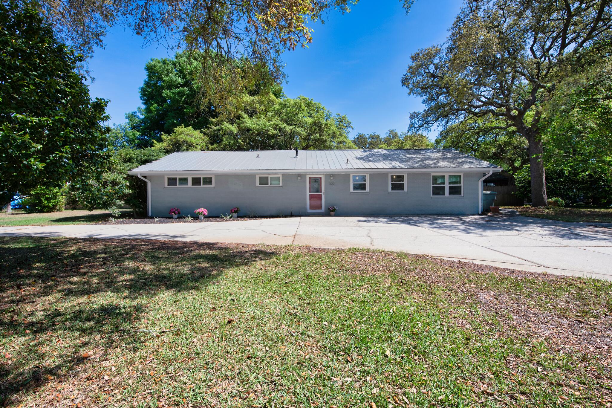 MULTIPLE OFFERS. HIGHEST & BEST BY 4/18 5PM. Move-in ready and fully upgraded in the heart of Fort Walton Beach! This beautifully renovated 3BR/2BA home sits on a large corner lot just minutes from parks, schools, shopping, dining, and the beaches. Enjoy great curb appeal with a manicured lawn, circle driveway, and fenced backyard featuring shed, and room for a pool. Inside, the open floor plan offers tile flooring throughout, recessed lighting, and a versatile sunroom perfect for extra living or office space. The farmhouse-style kitchen features granite countertops, stainless appliances, and a breakfast bar overlooking the spacious living and dining areas ideal for entertaining. The primary suite includes dual vanities, his-and-hers closets, and a subway-tiled shower.  Additional highlights include indoor laundry and generously sized guest rooms.
Major upgrades include a metal roof, HVAC, energy-efficient windows with faux wood blinds, copper wiring, tankless water heater, and a whole-home generator.
Style, space, and location - this home checks all the boxes!
