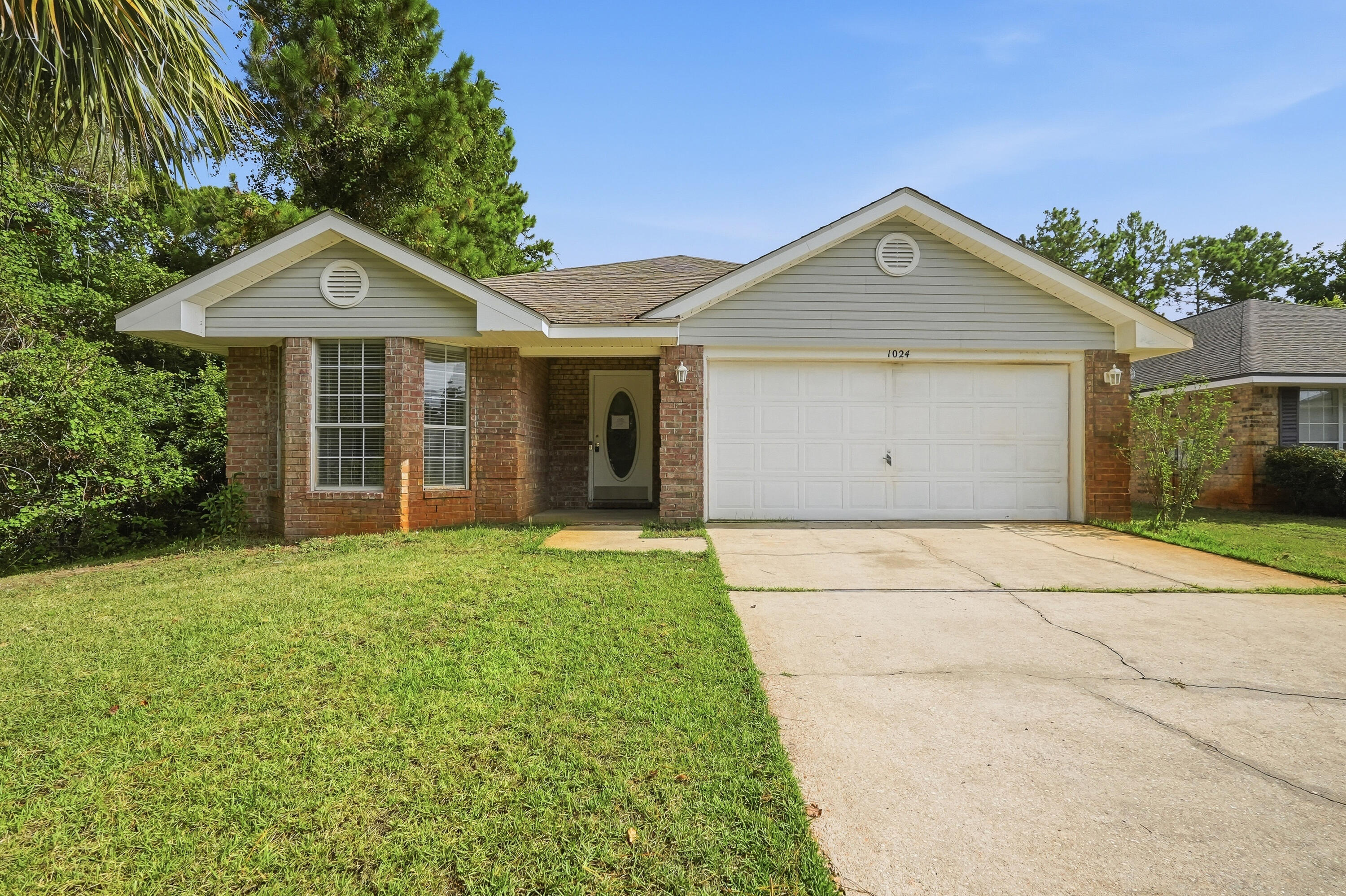VA REO Property.  Prime location near Hurlburt Field and Navarre's beaches. Positioned at the very end of a cul-de-sac, this all-brick home offers rare privacy with only one adjacent neighbor. The exterior is low-maintenance brick with vinyl soffits; a quick pressure wash will enhance curb appeal instantly. Indoors, fresh paint would elevate the clean, solid interior. The kitchen includes white cabinetry, granite countertops, and stainless steel appliances. Luxury vinyl plank flooring--in good condition except for two small areas in the primary bedroom-  Enjoy a split-bedroom layout, vaulted living room, and dining space just off the kitchen. The primary suite features double vanities, a separate shower and tub, and a large walk-in closet. Move-in ready with simple cosmetic updates to make it feel brand new.