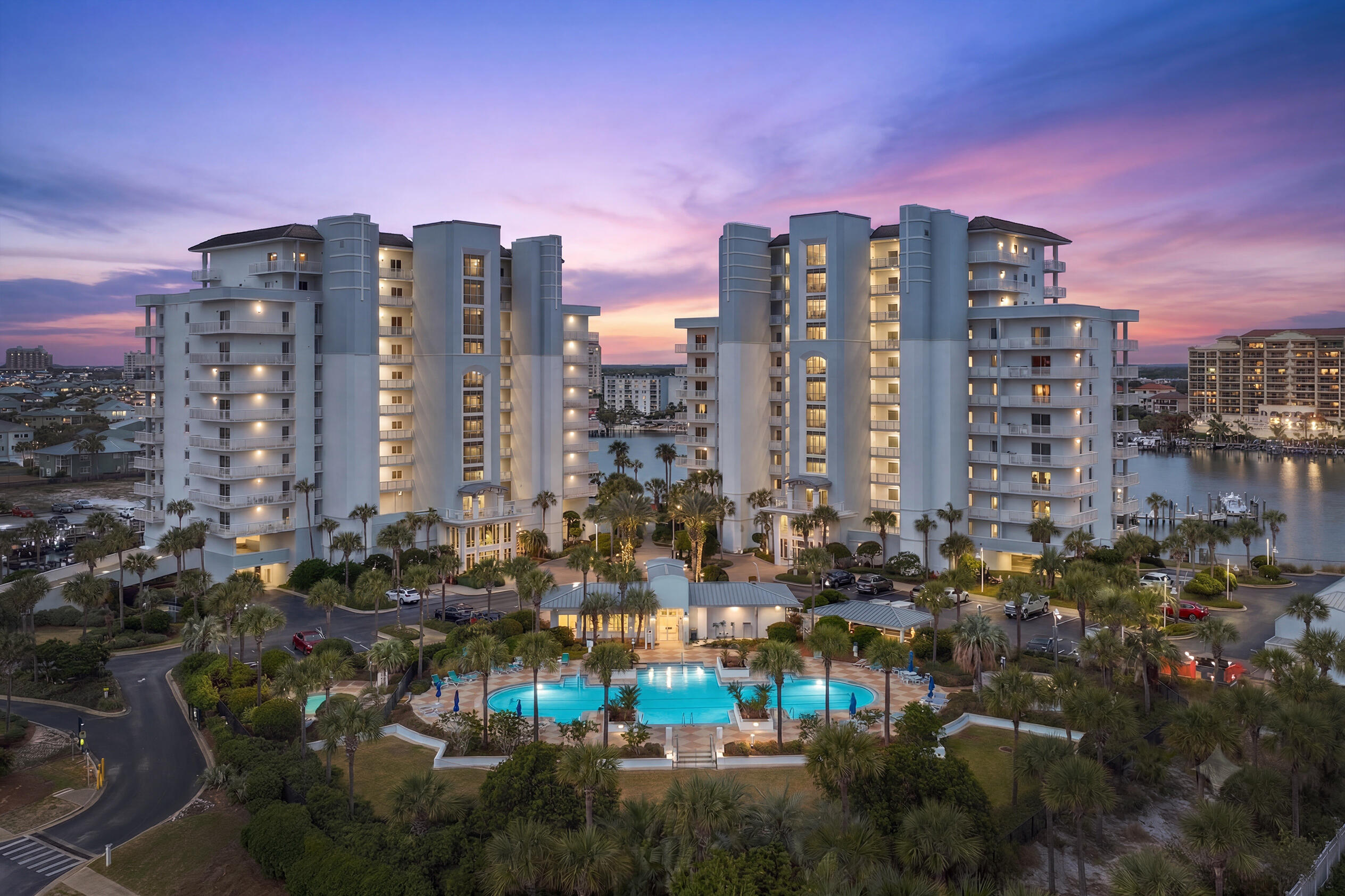 There are waterfront condominiums, and then there is Harbor Landing. A private waterfront community where luxury living, boating, and the Emerald Coast lifestyle come together in one extraordinary destination. As the newest condominium development on Destin Harbor, Harbor Landing offers a residential experience unlike any other. Designed to live like a luxury single-family home, these expansive residences feature oversized living spaces, extra-wide hallways, soaring 10-foot ceilings, 9-foot doors, and an exceptional split-bedroom floor plan that provides both comfort and privacy.

The true luxury, however, is the lifestyle. Begin your mornings with coffee overlooking Destin Harbor as charter boats idle toward the Gulf. Spend the afternoon on the sugar-white sands using your private deeded beach access directly across the street. Keep your boat at the marina, launch a paddleboard from the dock, or simply relax while watching the harbor come to life. As evening arrives, call the Destin Water Taxi from your private marina and cruise across the harbor for waterfront dining, live music, and sunset cocktails at HarborWalk Village or one of Destin's renowned harbor-front restaurants. No traffic. No searching for parking. Just an unforgettable way to experience Destin.

Offering approximately 2,377 square feet, this beautifully appointed fourth-floor residence is offered fully furnished and professionally designed with furnishings from Stock & Trade Design Co. and Rissa's Interiors, creating a sophisticated coastal aesthetic that is completely turnkey. Every bedroom features its own private en-suite bath, complemented by a convenient half bath for guests. Updated countertops, spacious living areas, and breathtaking views of both Destin Harbor and the Gulf of Mexico create a residence that is equally suited for full-time living, a second home, or a luxury vacation rental.

One of this residence's most desirable features is its oversized covered balcony. Larger and extending farther from the building than many others, it functions as a true outdoor living room--perfect for morning coffee, afternoon relaxation, outdoor dining, or entertaining in every season while enjoying panoramic harbor and Gulf views.

Adding to the convenience is a rare private exterior storage room, providing abundant space for beach chairs, fishing equipment, paddleboards, seasonal décor, bicycles, coolers, luggage, and even an additional refrigerator or freezer--an exceptional amenity seldom found in waterfront condominiums.

Harbor Landing's gated amenities include two swimming pools, including a private owners-only pool, deeded beach access, two hot tubs, a fitness center, marina with boat slips, barbecue area, paddle board launch, on-site management, and secure building access. The community has also completed its Structural Integrity Reserve Study, offering added confidence in the property's long-term stewardship.

Whether you're searching for a luxurious primary residence, an exceptional second home, or a high-performing vacation rental, few properties in Destin offer the unique combination of spacious residential living, private boating, deeded Gulf beach access, and effortless waterfront dining that defines life at Harbor Landing.
